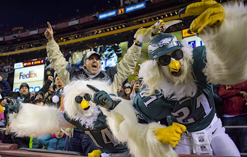 EaglesFans.jpg A pair of people dressed up as eagles stand up and cheering during and NFL game between the Philadelphia Eagles and Washington Redskins; nfl cities travel