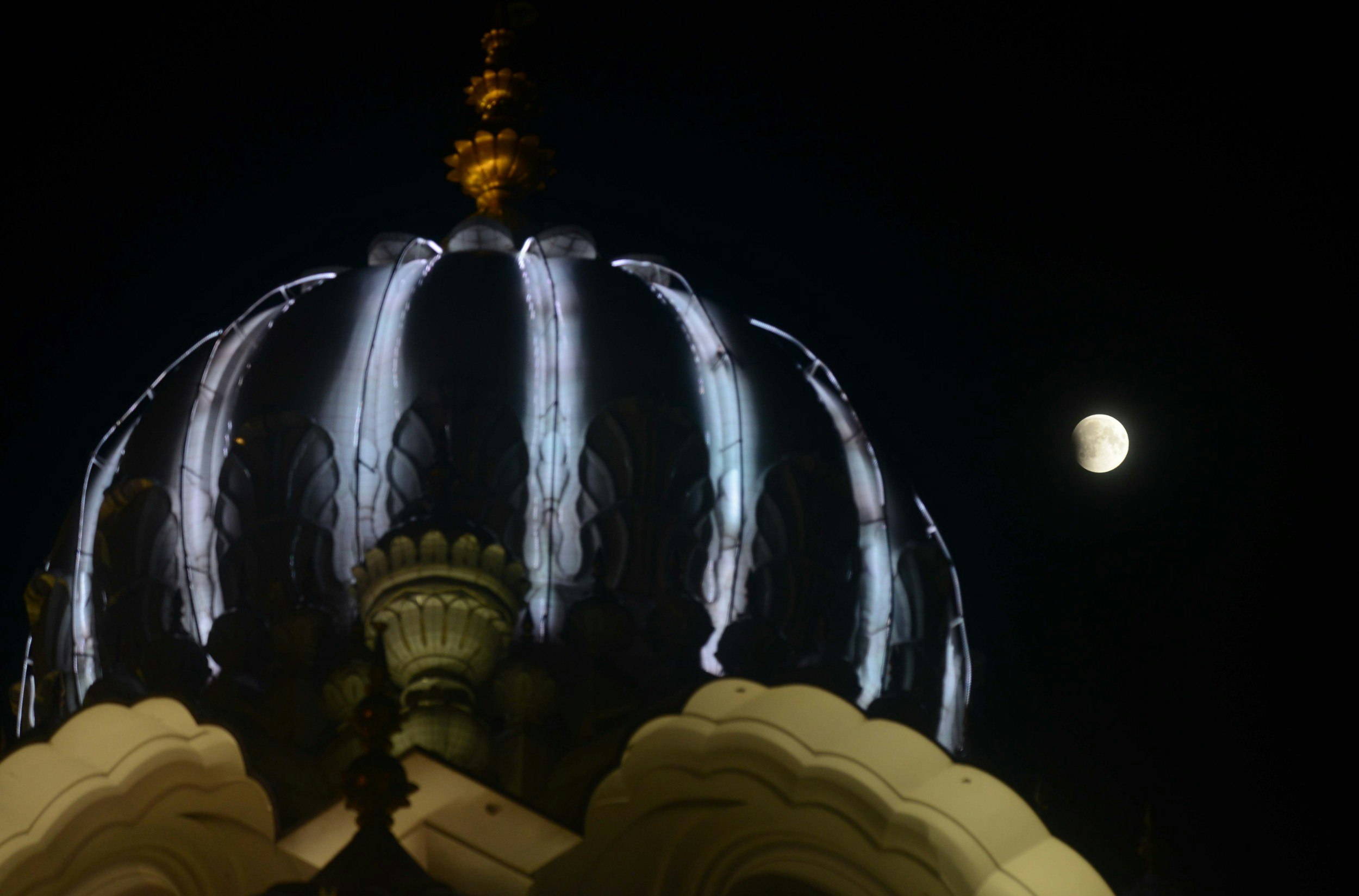 The full moon eclipse beside the Golden temple in Amritsar 