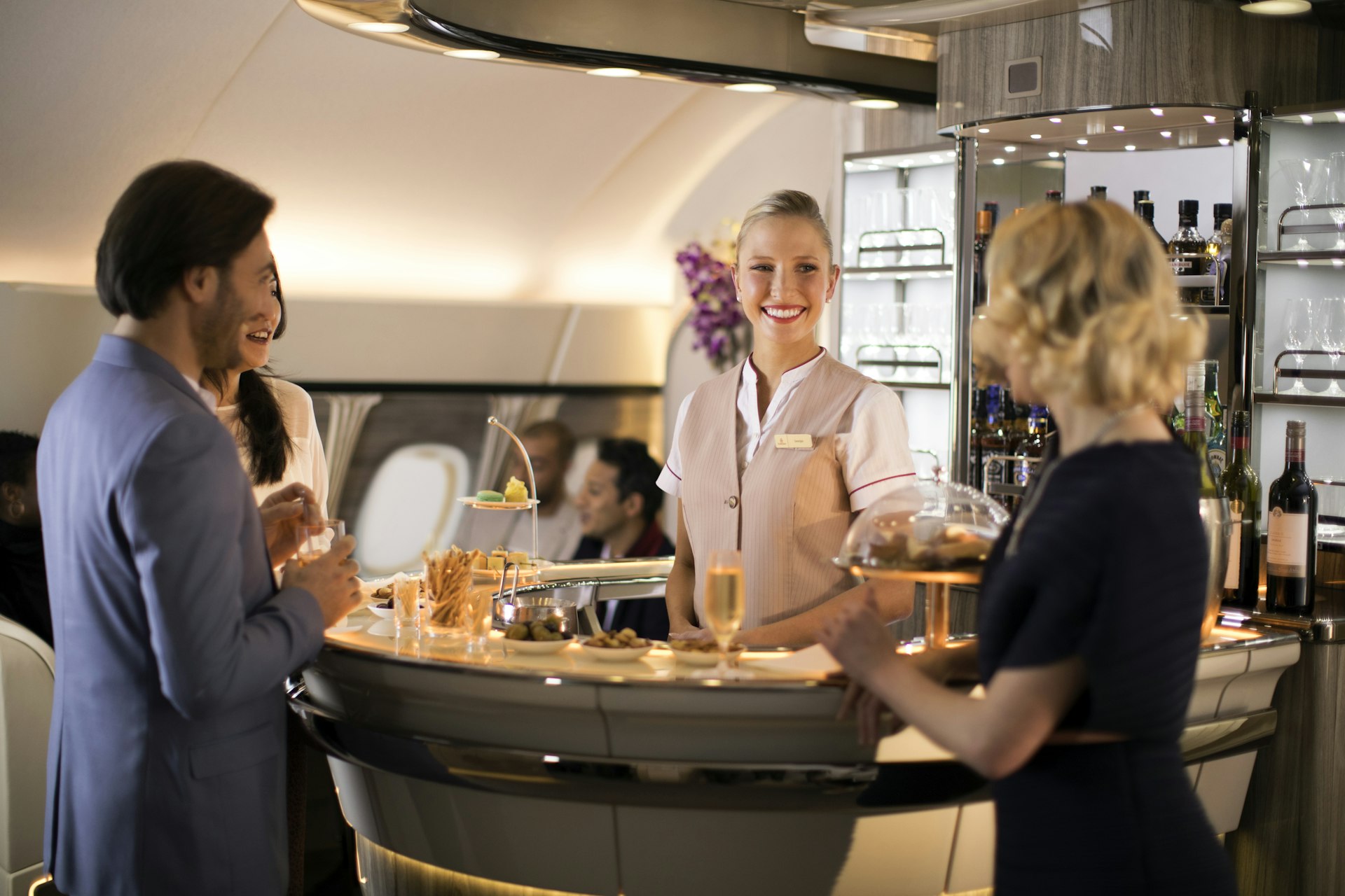 Passengers on an Emirates flight enjoy a drink at the bar