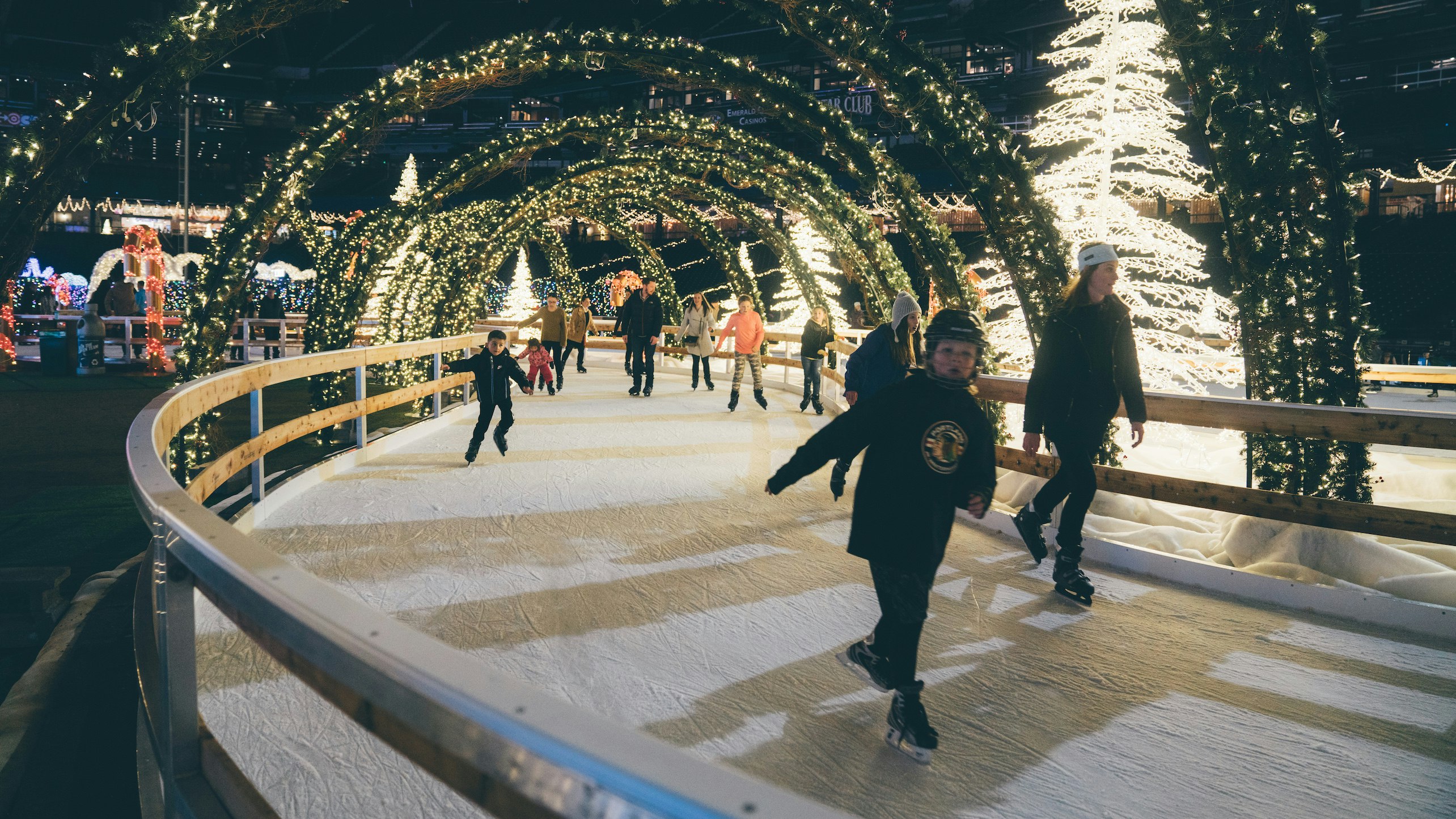 A crowd skating through an illuminated Christmas maze 