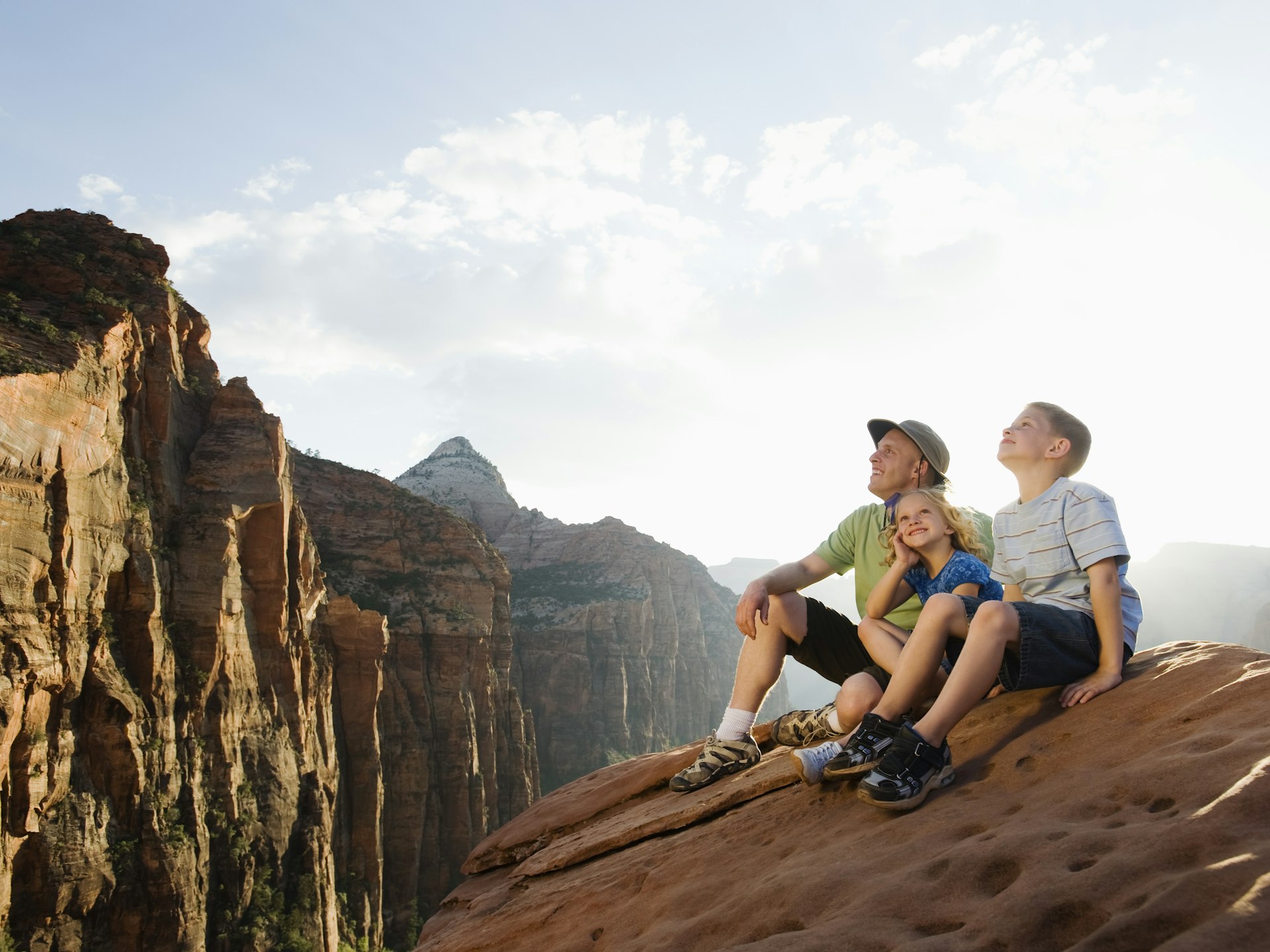 A father and kids sitting at Red Rock Canyon.
