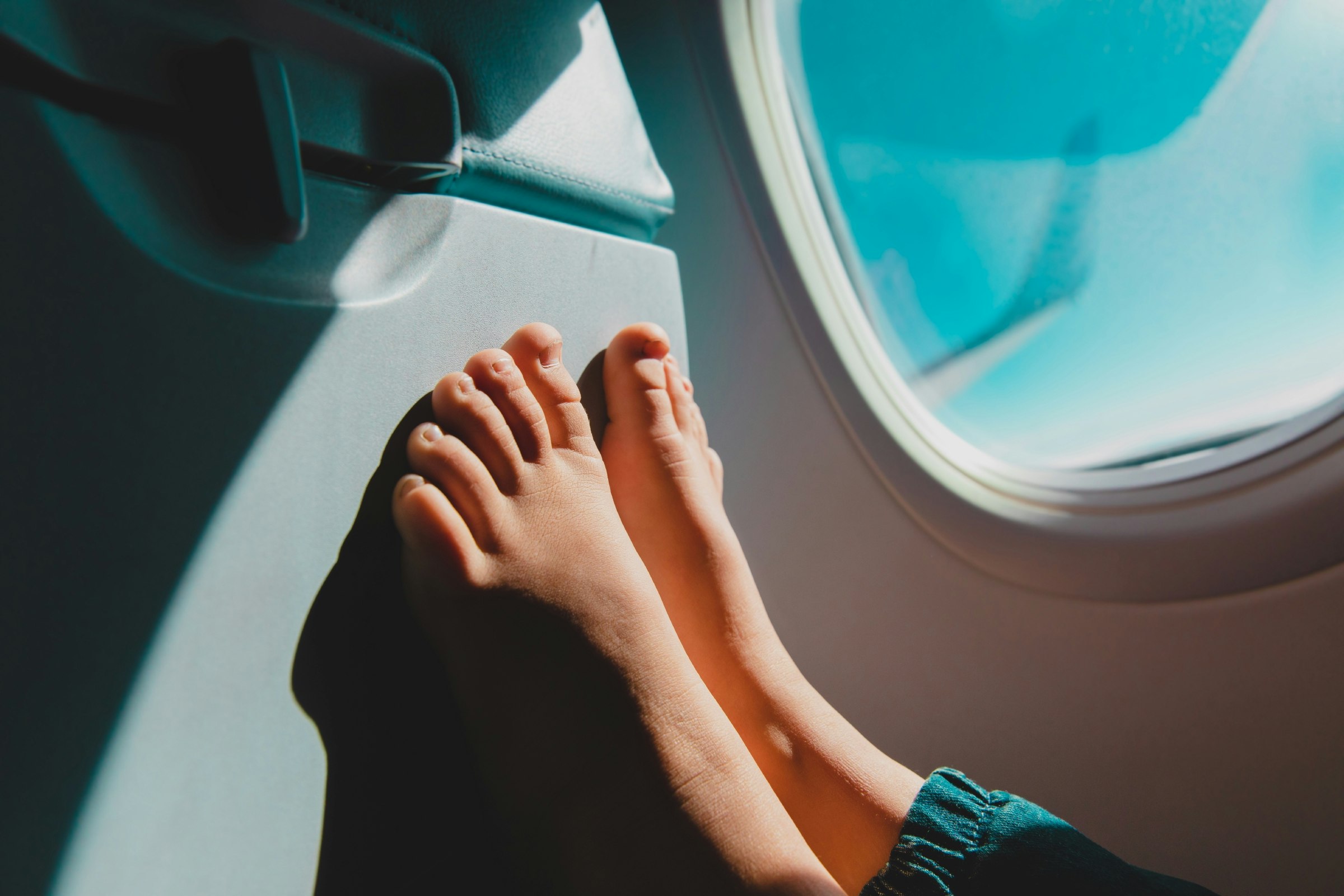 Bare feet on back of tray table