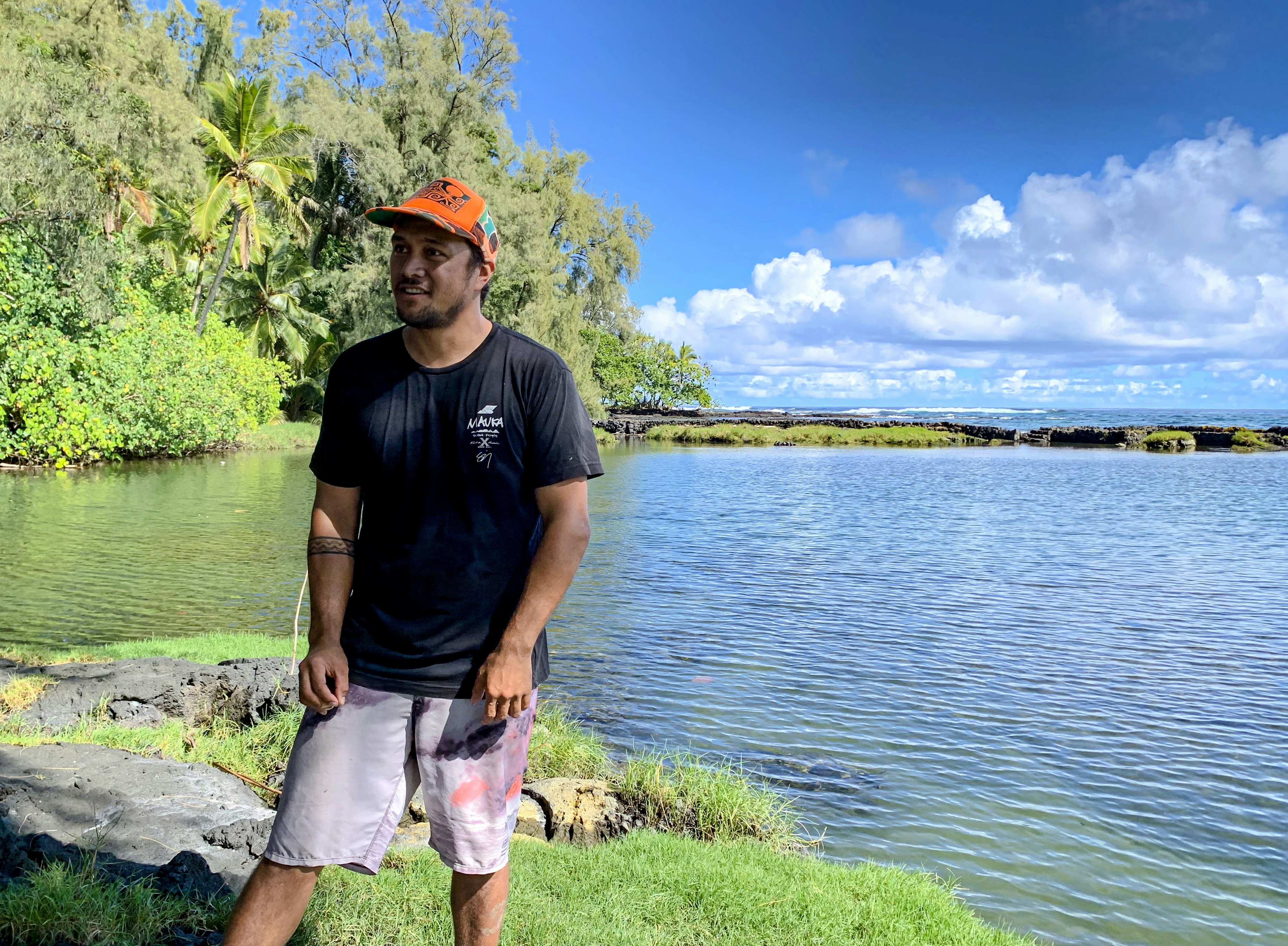 Luka Kanakaʻole standing in front of a fishpond