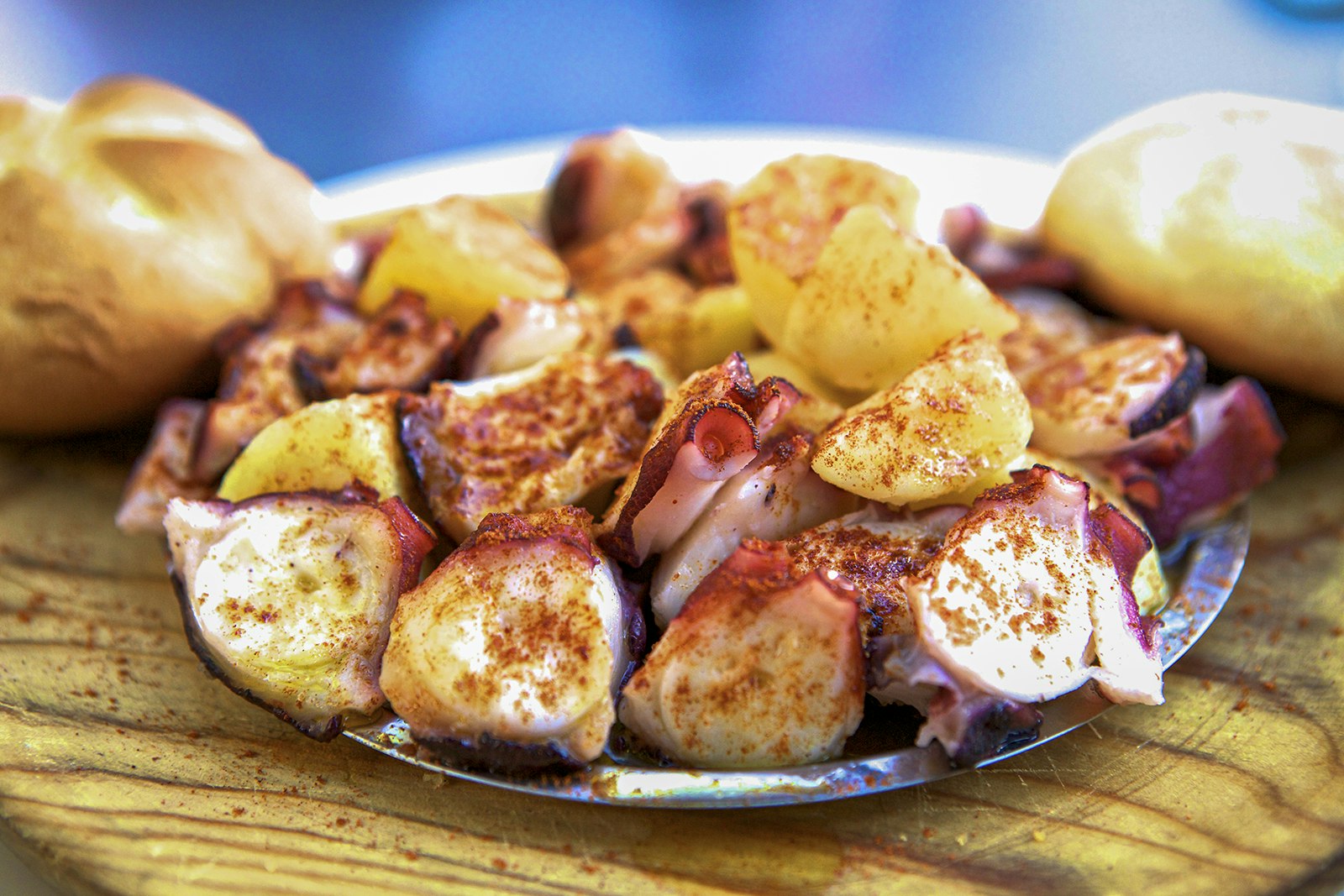 A close-up of seafood tapas sprinkled with spices and served in a metal dish. Cádiz, Spain