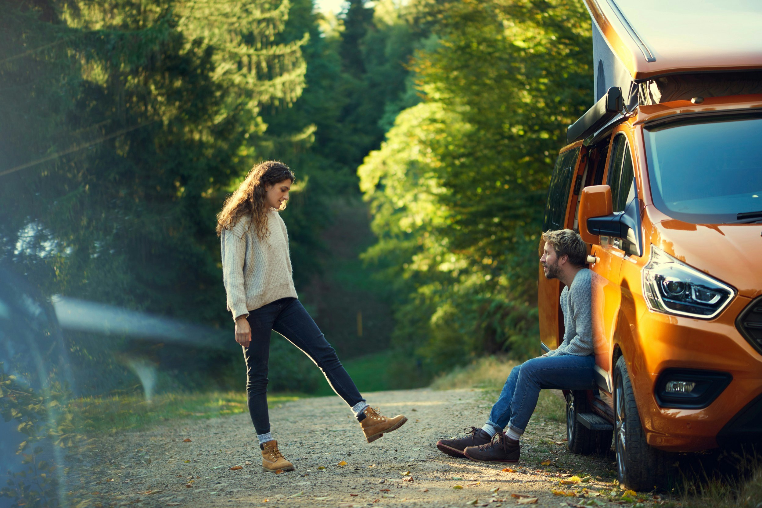 Two people sitting oustide a Ford Transit Custom Nugget 