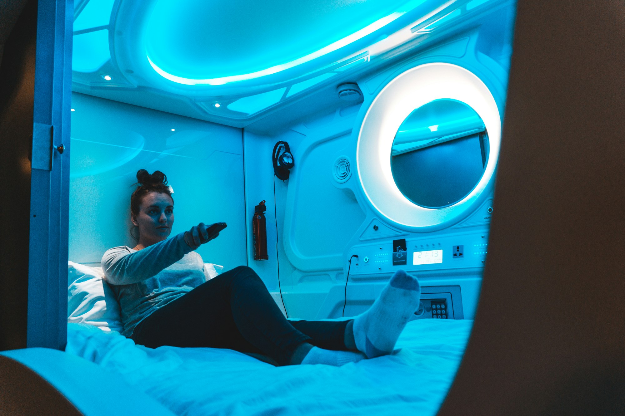A woman inside a pod at Galaxy Pod Hostel Iceland