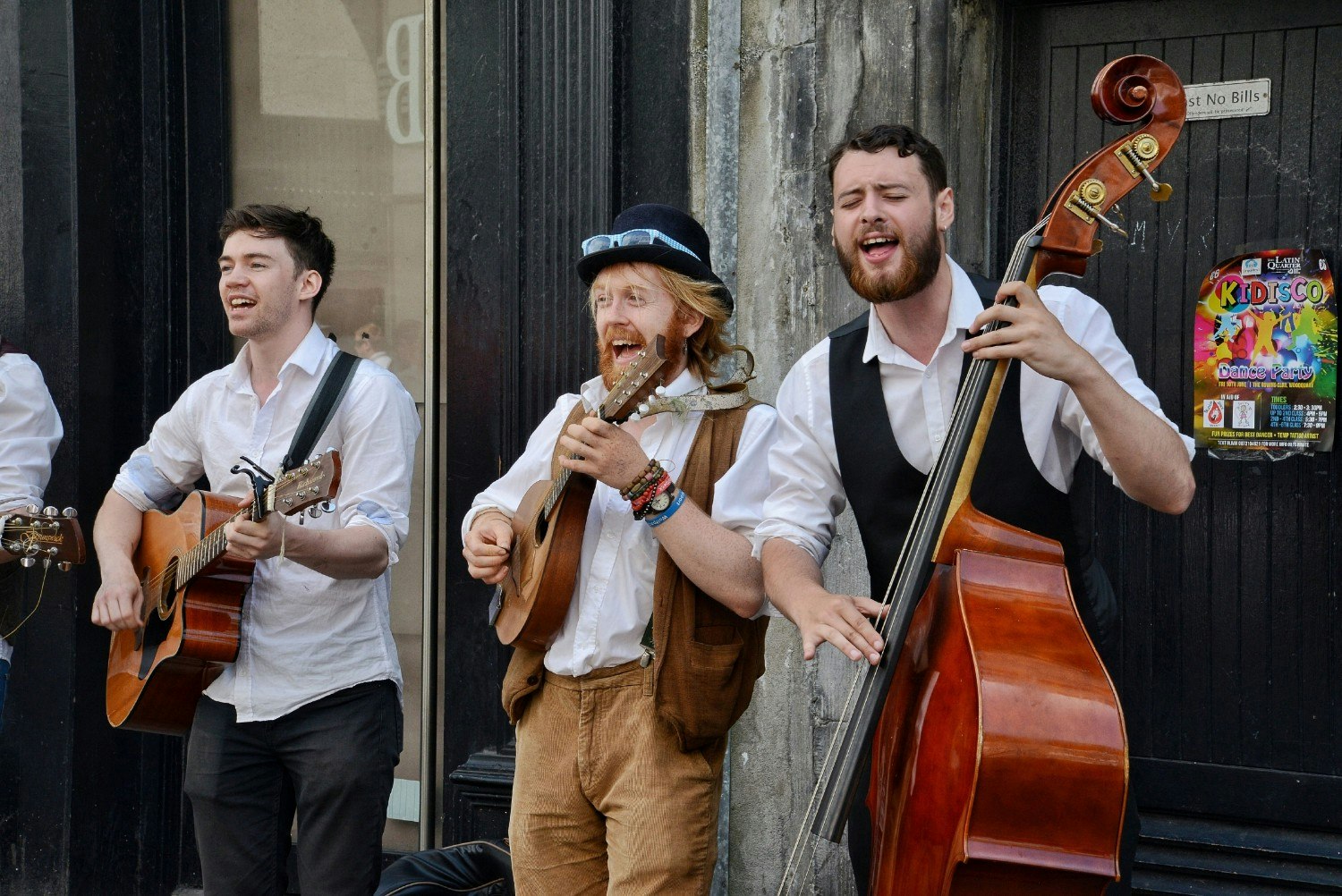 Three buskers performing music on the streets of Galway.