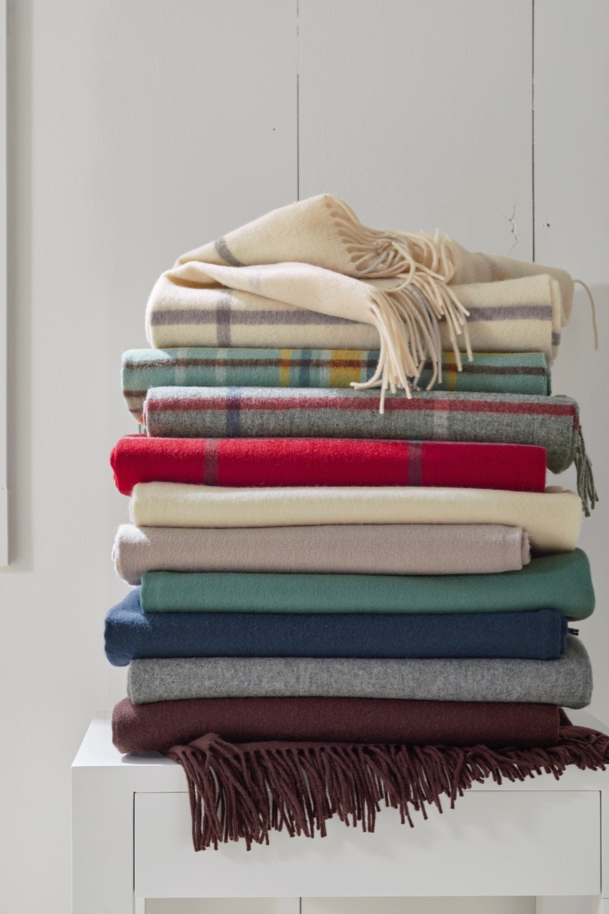 A stack of multicolored wool and cashmere throws from Garnet Hill