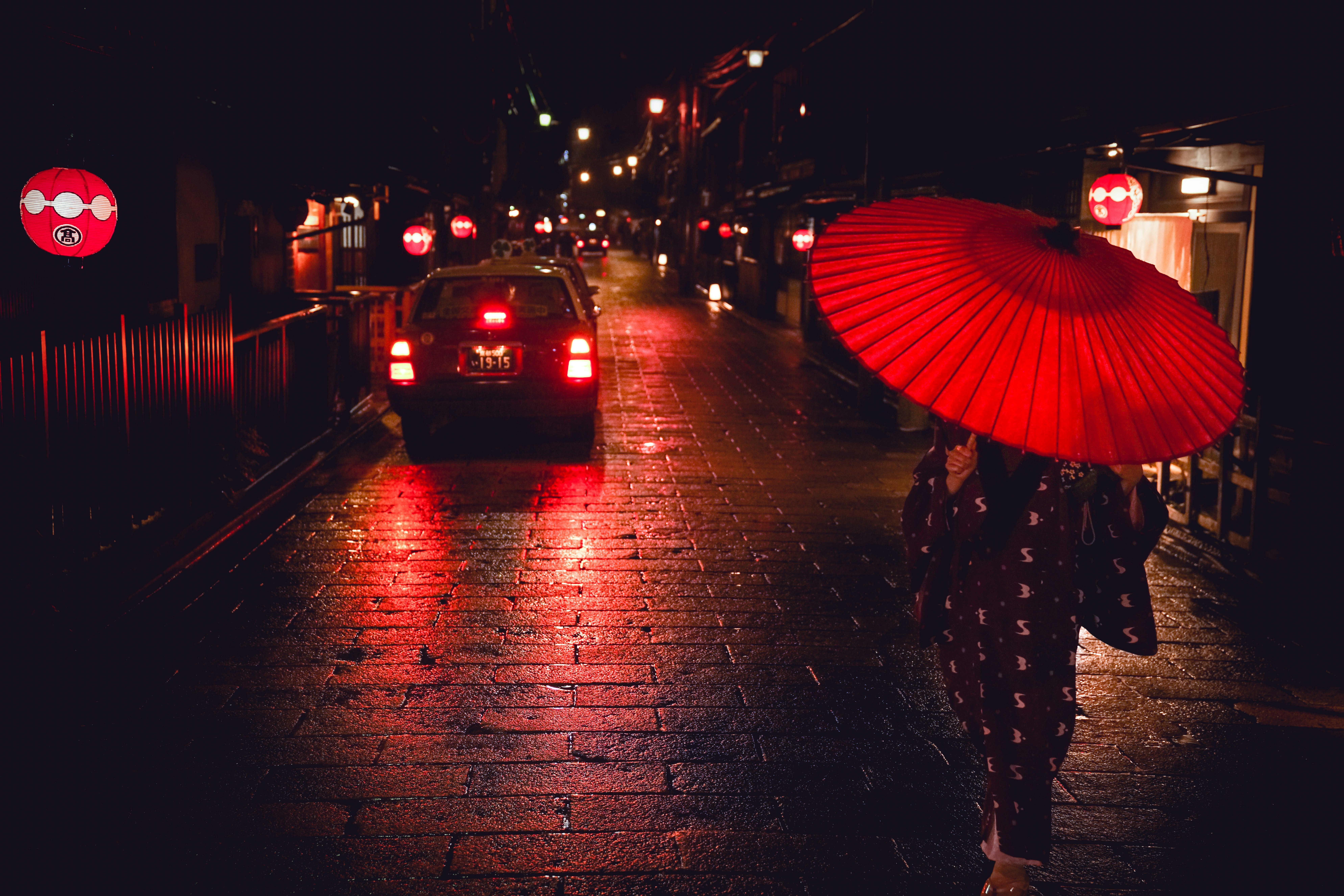 A Geisha walks through Gion at night