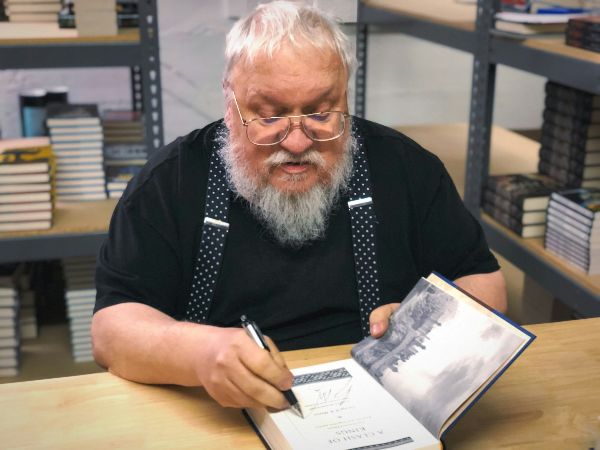 George RR Martin signing copies of his own books