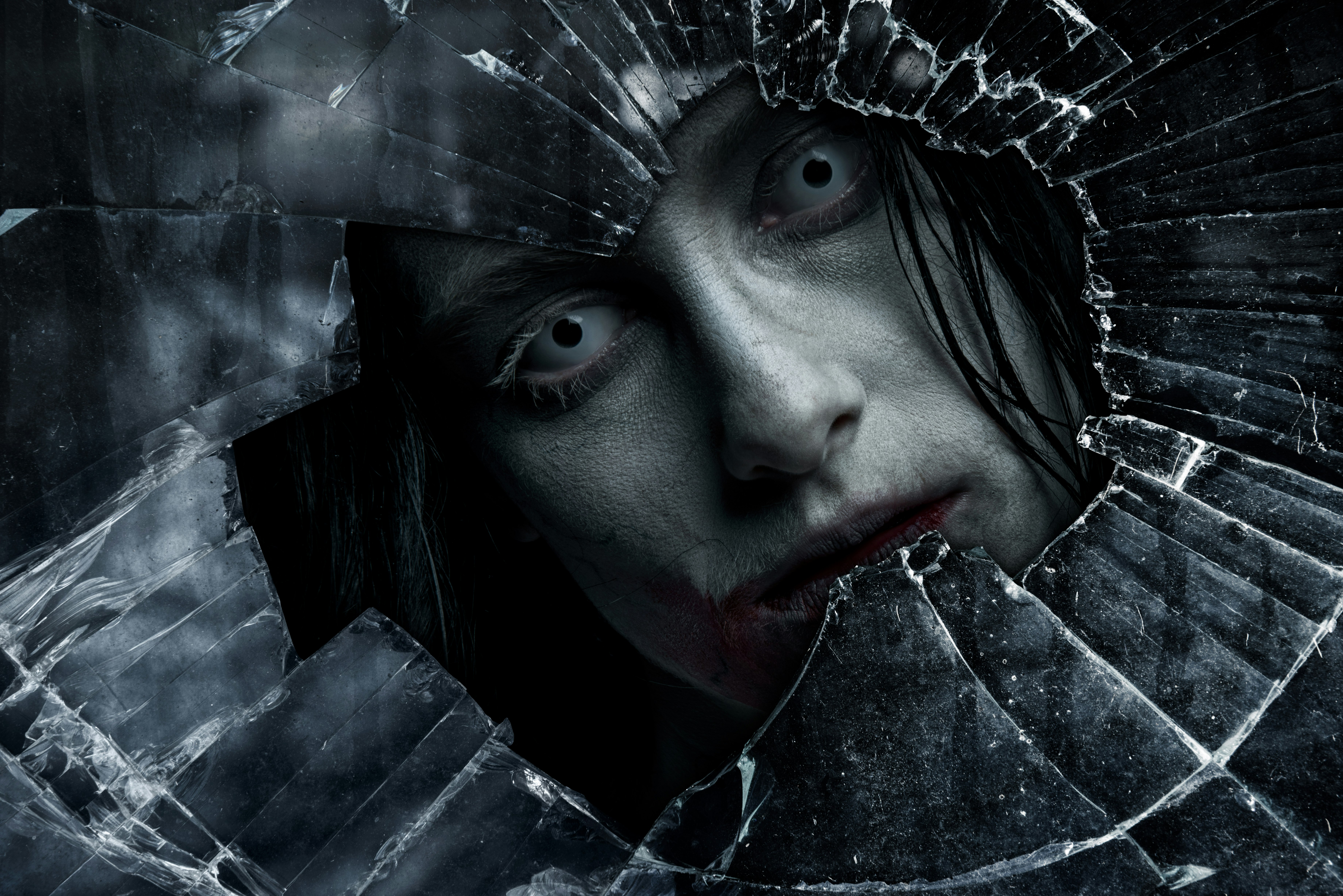 Zombie looks through cracked glass