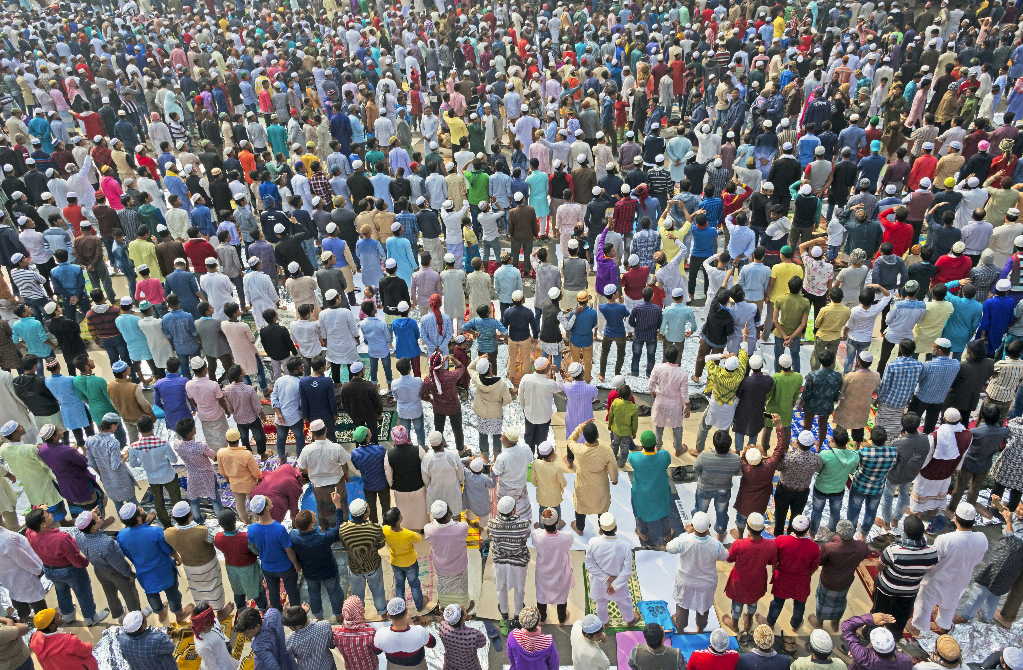 An aerial view of a huge crowd of worshippers outside a mosque in Dakar, which creates a colourful scene.