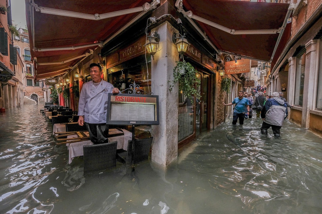 Cafes and alleyways are submerged under water in Venice
