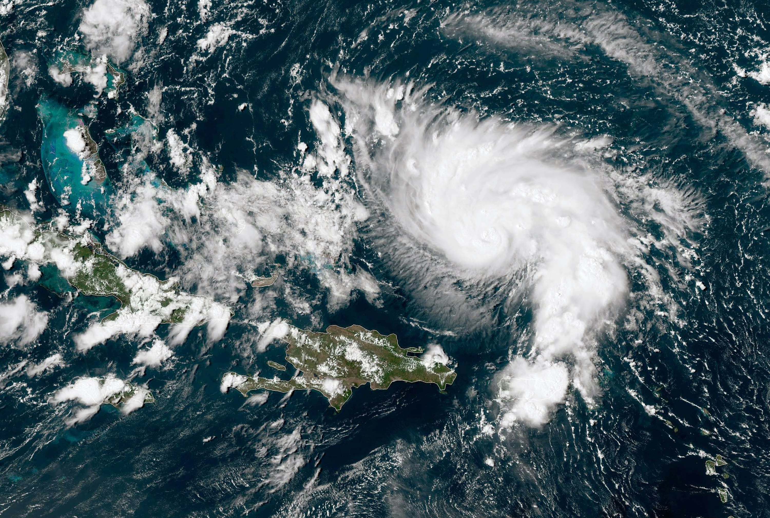 An image shows a satellite view of Hurricane Dorian. 