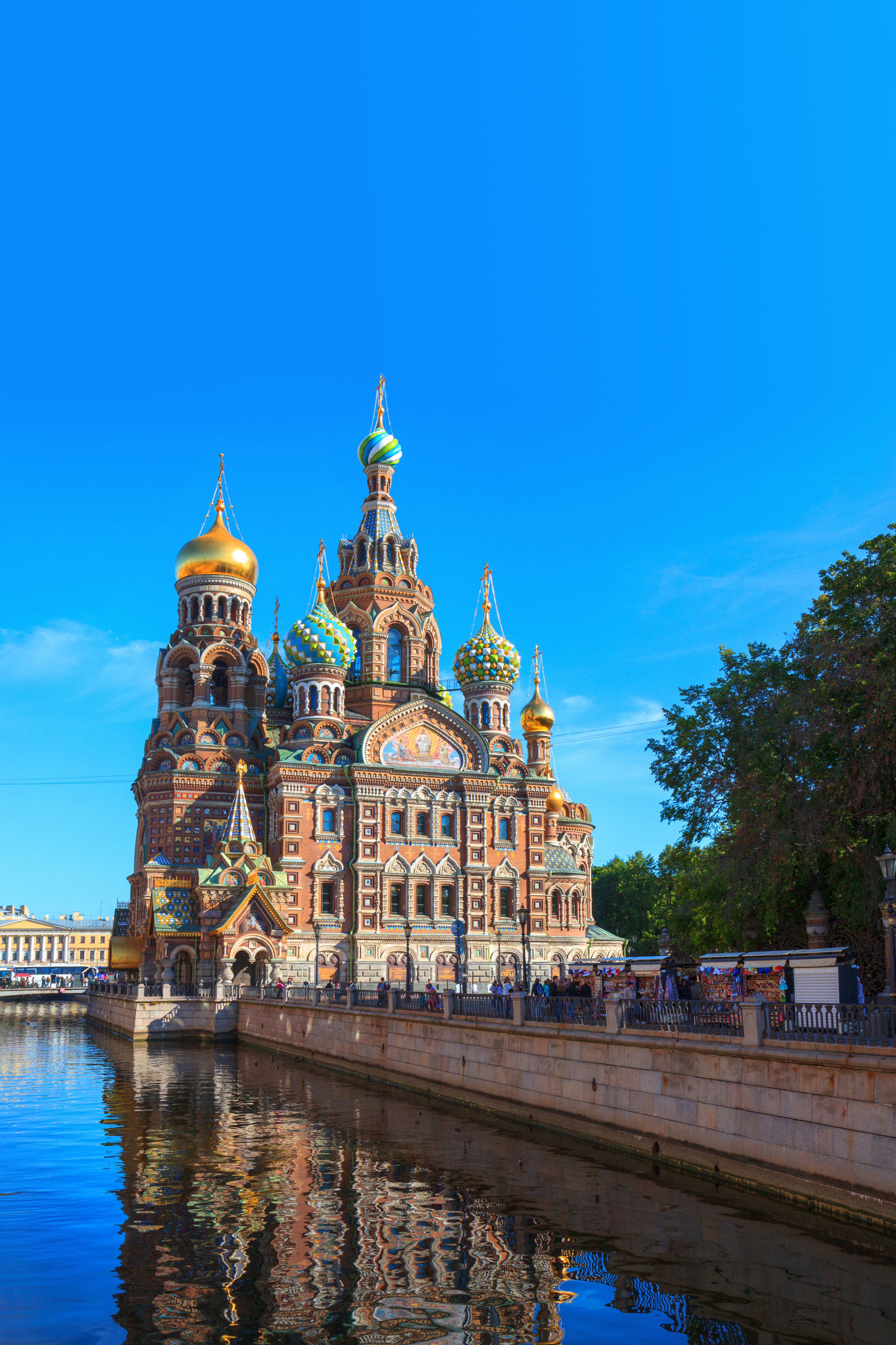 The colourful spires and golden domes of St Petersburg's Church of the Saviour on the Spilled Blood, against a clear blue sky