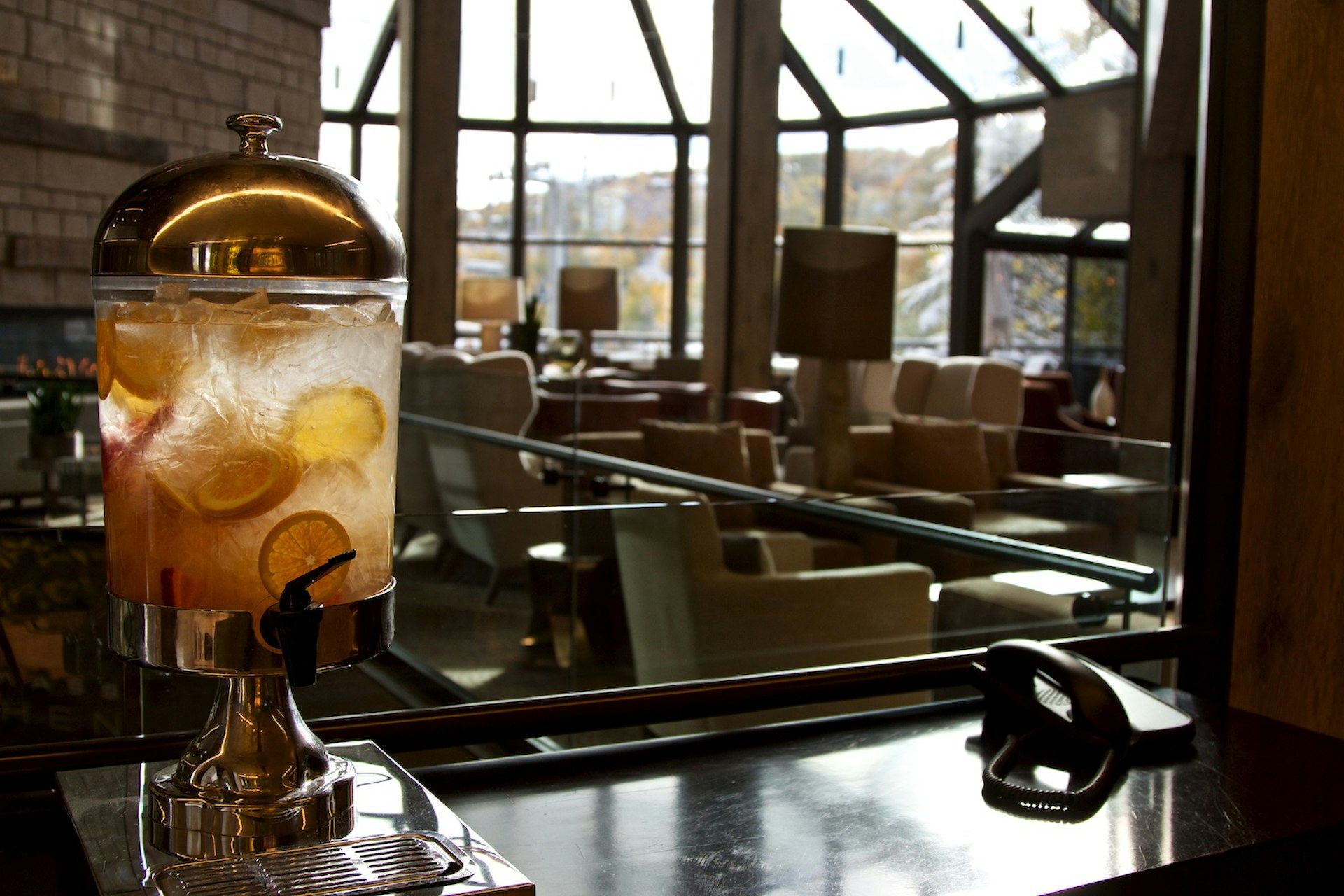 A large pitcher of lemon water on a hotel lobby bar