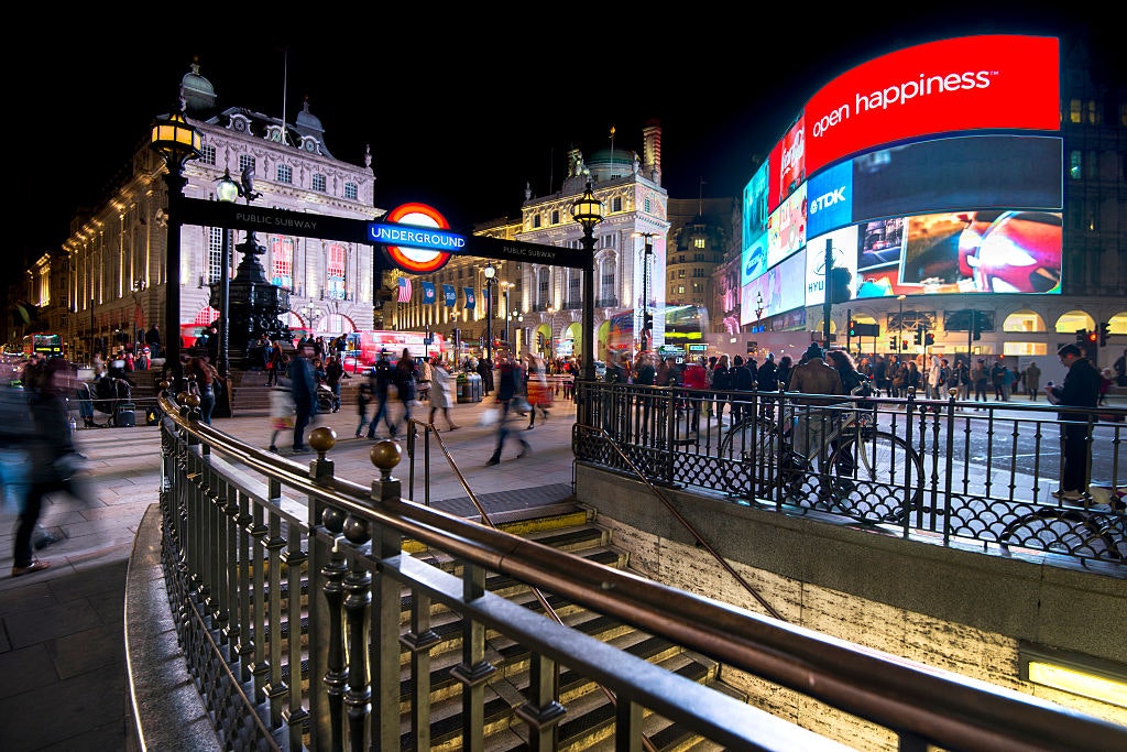 Long exposure of pedestrians and traffic outside Piccadilly Circus tube station in London,