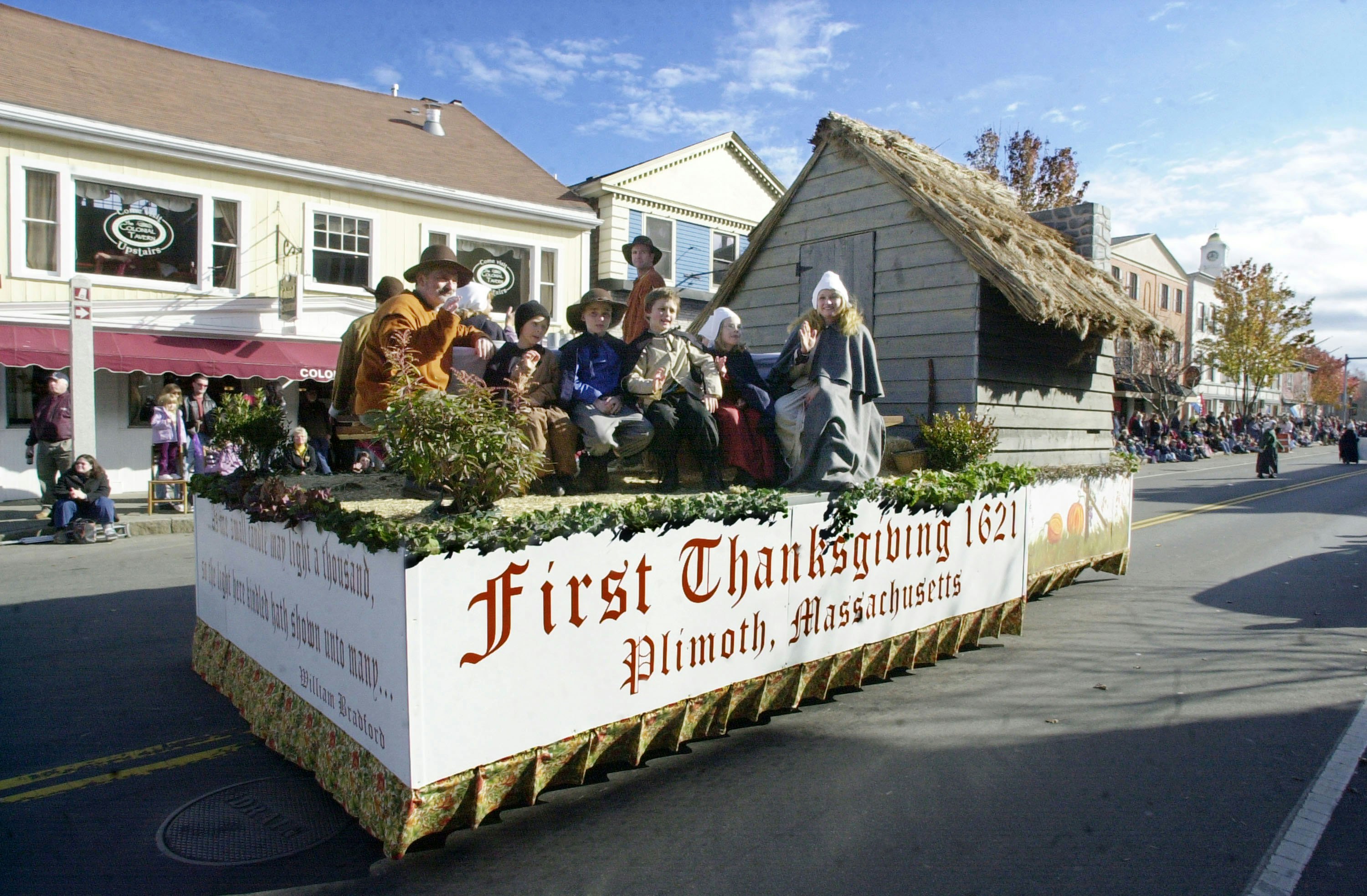 Townspeople dressed as pilgrims ride on a float during the annual Thanksgiving Parade in Plymouth, Massachusetts