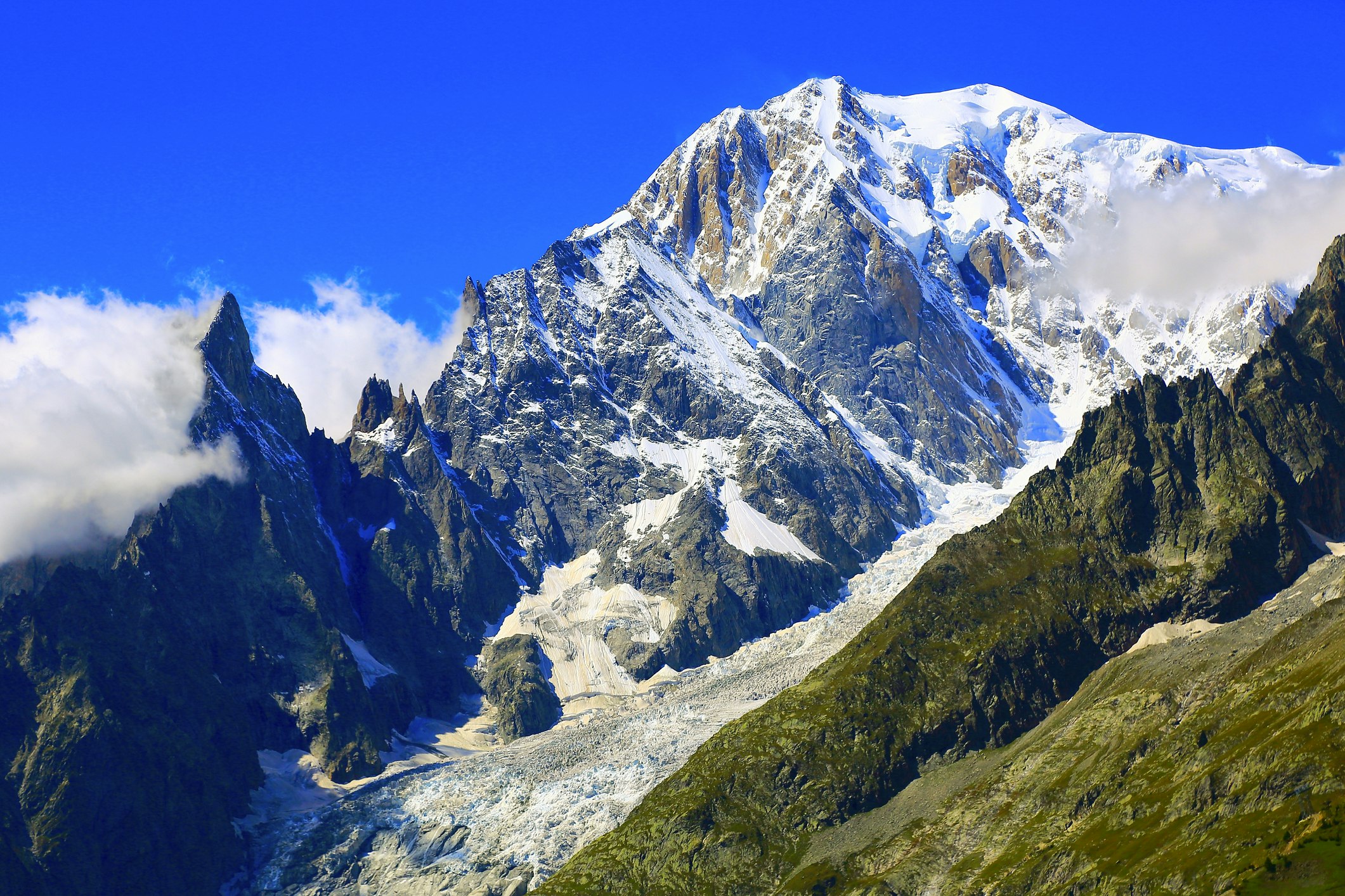 Blue sky and snowcapped mountain peak