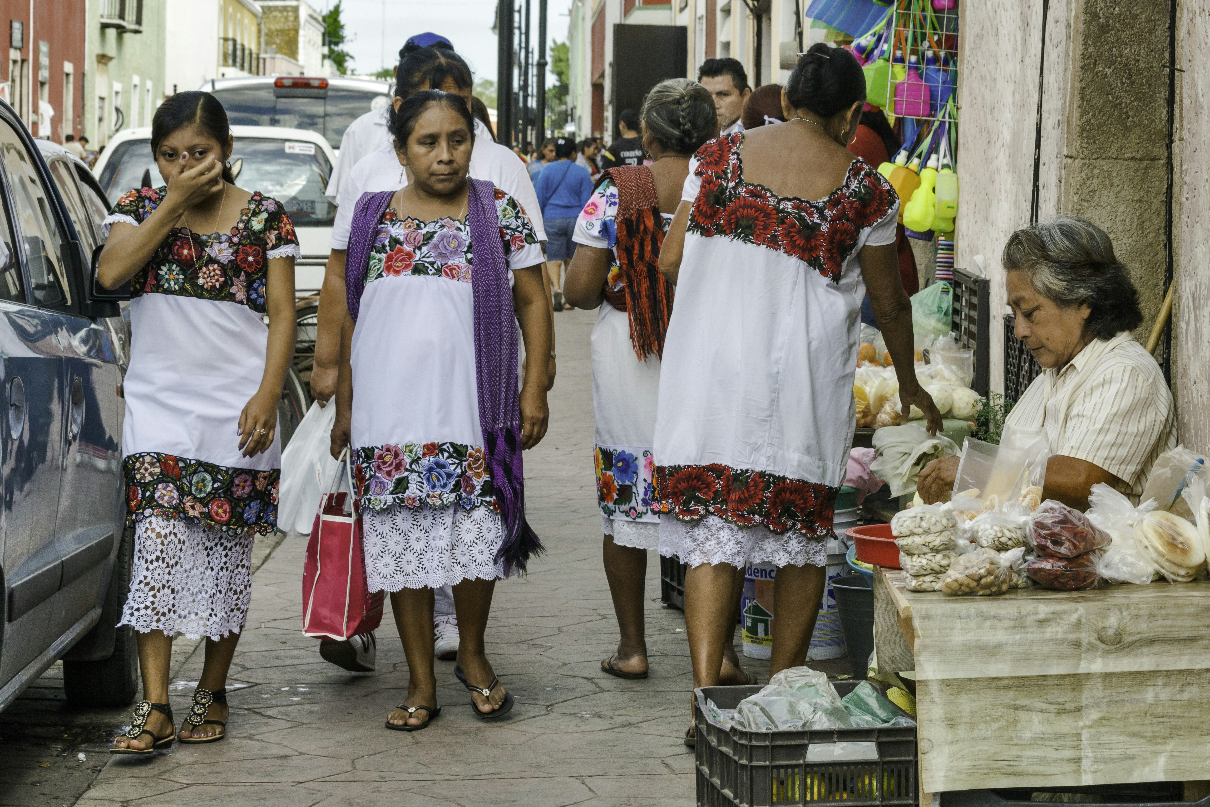 Women wearing huipiles, traditional hand-embroided Mayan dress, at Calle 44 in Valladolid, Yucatan state, Mexico.