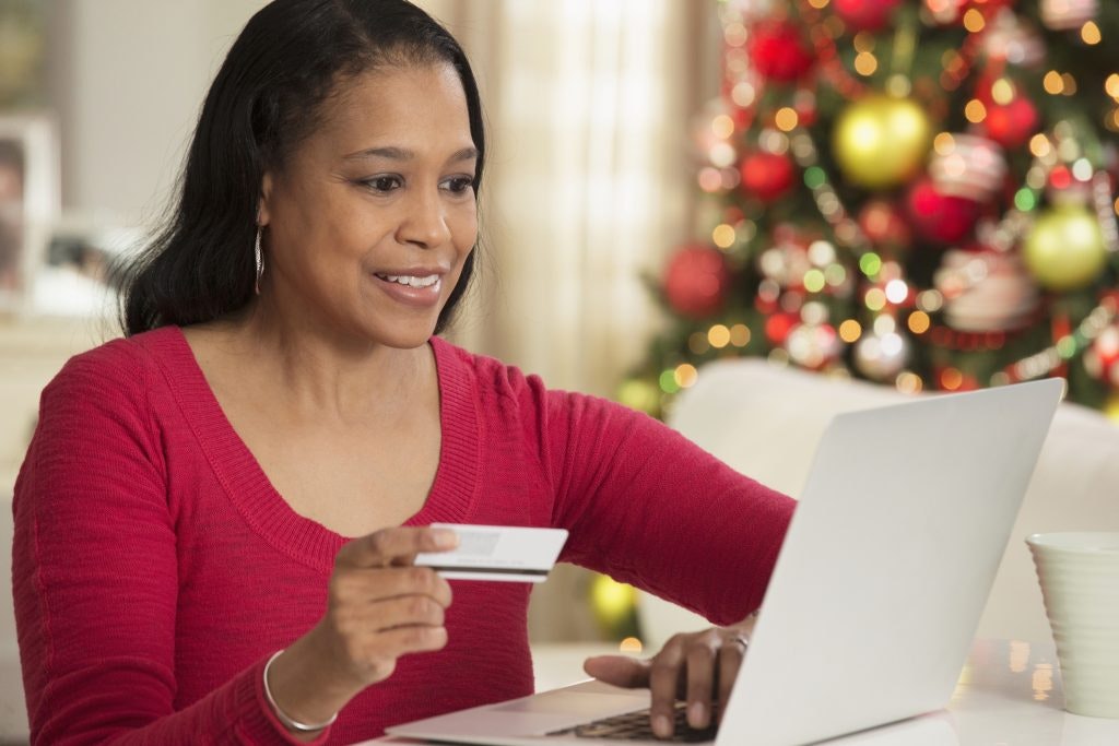 A woman using her credit card to purchase online