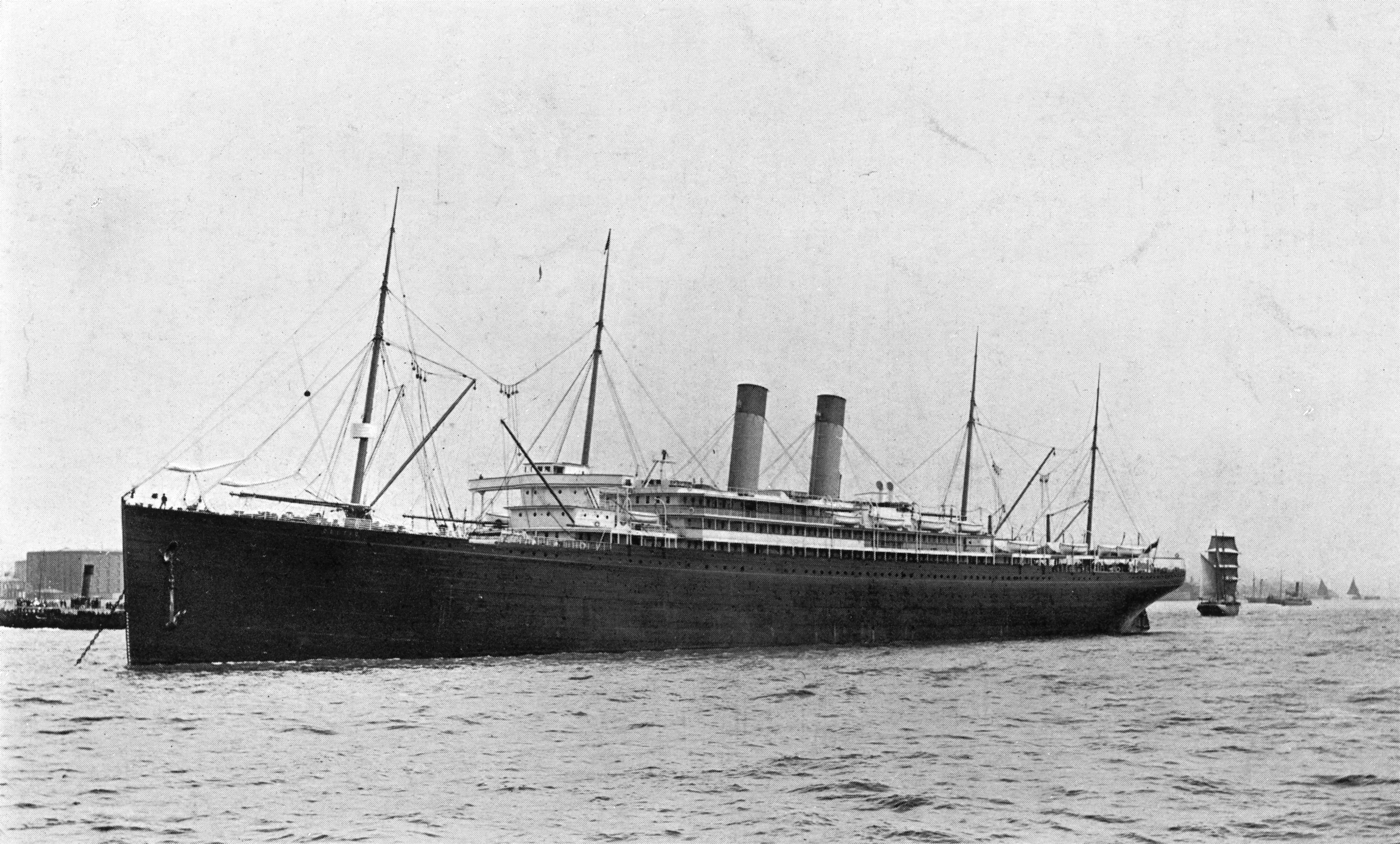 rms-celtic.jpg The RMS Celtic appears in this black and white photograph circa 1913 with two smoke stacks, four masts, and a long black hull angled towards the left side of the frame sailing towards, but past the viewer.