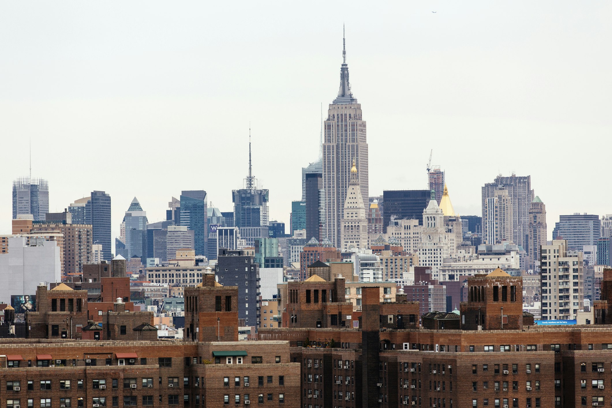 Manhattan skyline with Lower East Side on foreground and Empire State Building in the background.
