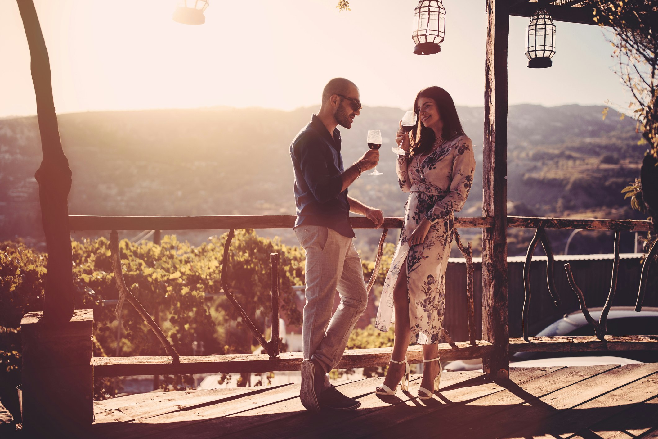Elegant couple drinking red wine at French rustic vineyard winery