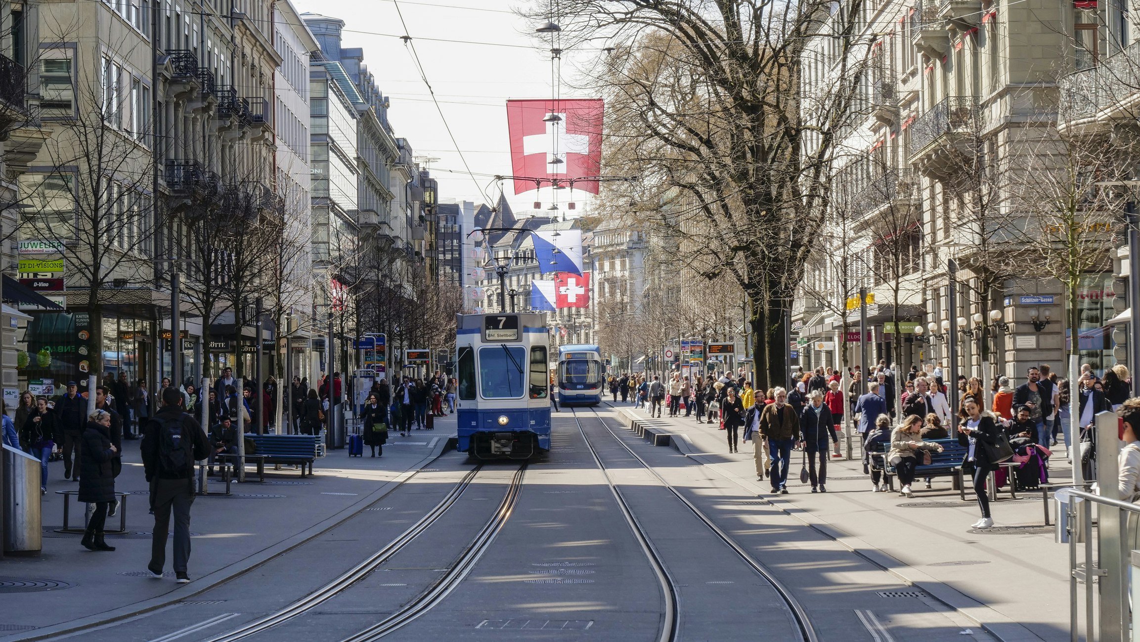 A tram on a busy shopping street in Zurich