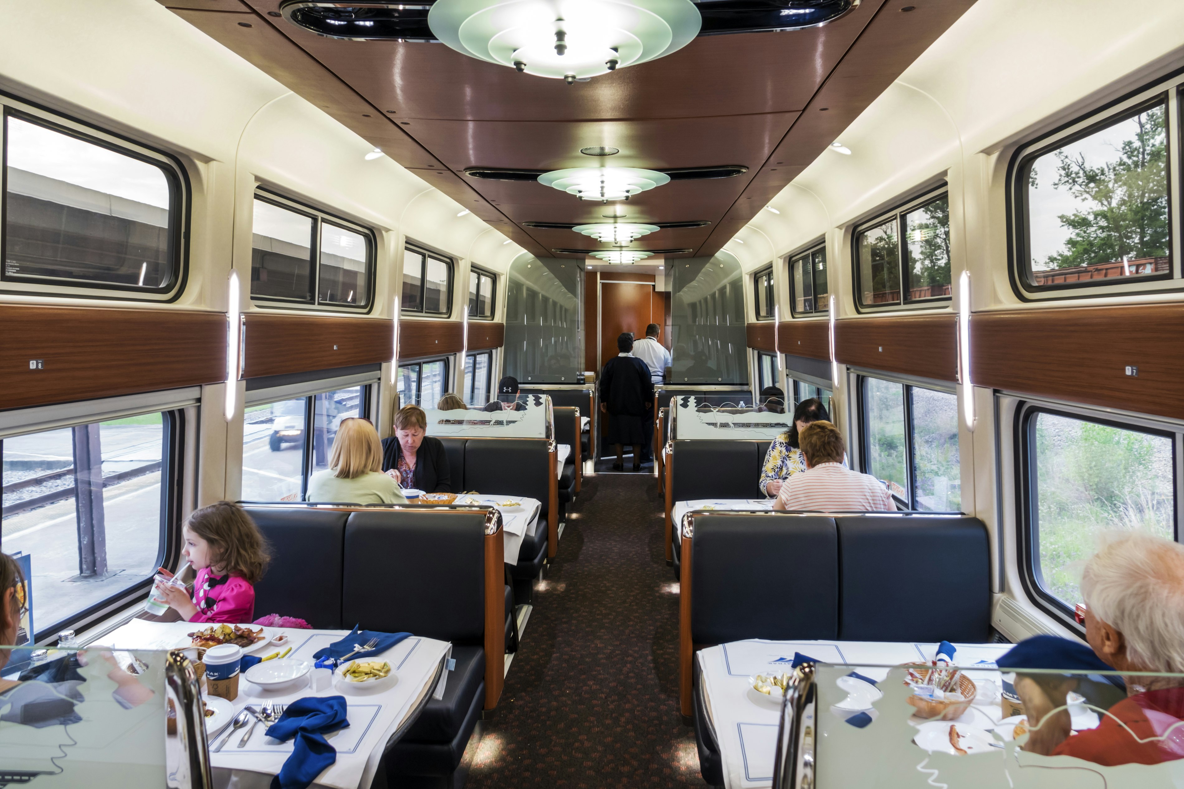 Scattering of young and old customers seated in Amtrak's dining car for breakfast service