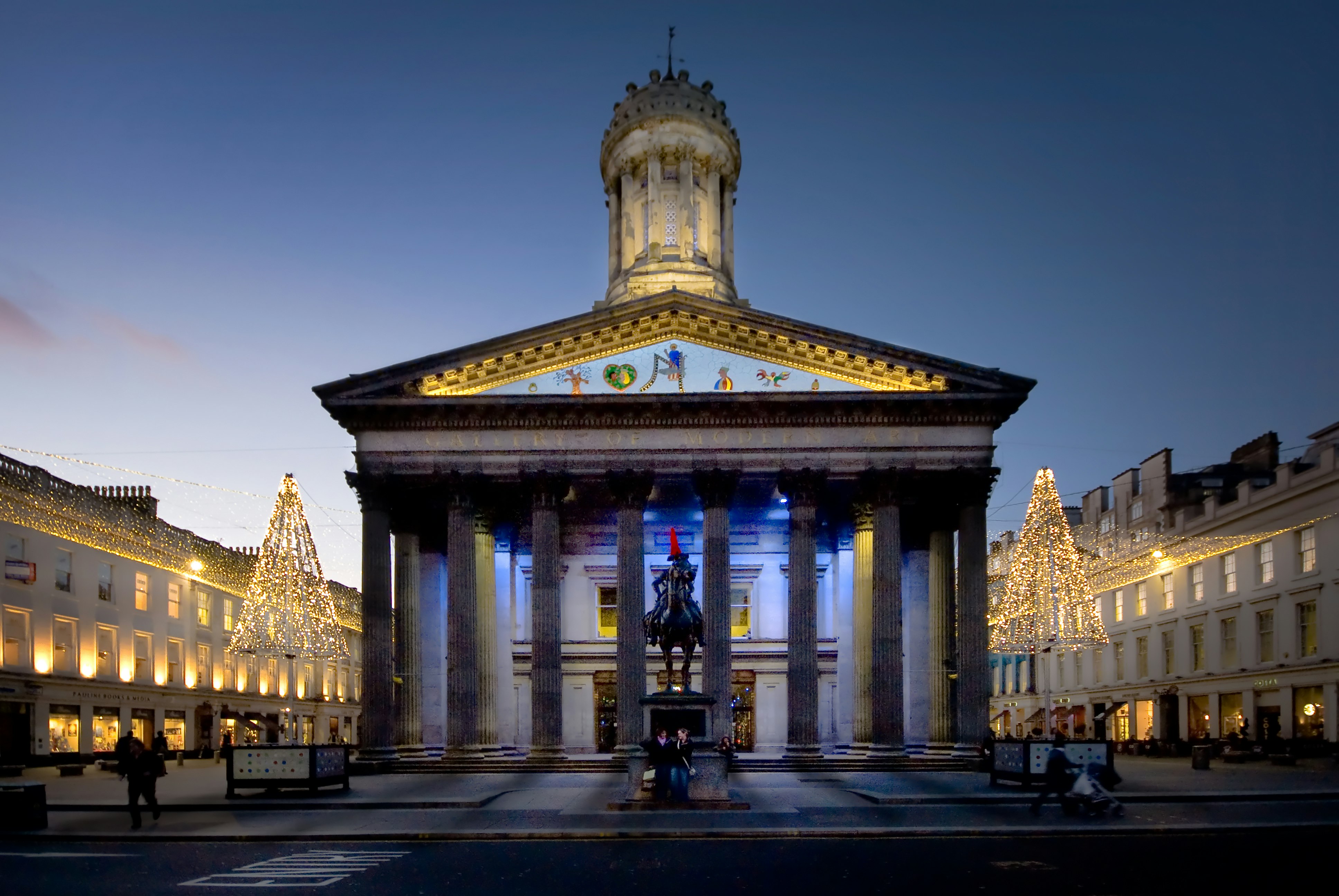Glasgow's Gallery of Modern Art, a neoclassical building with columns and a statue of a horseman in front.