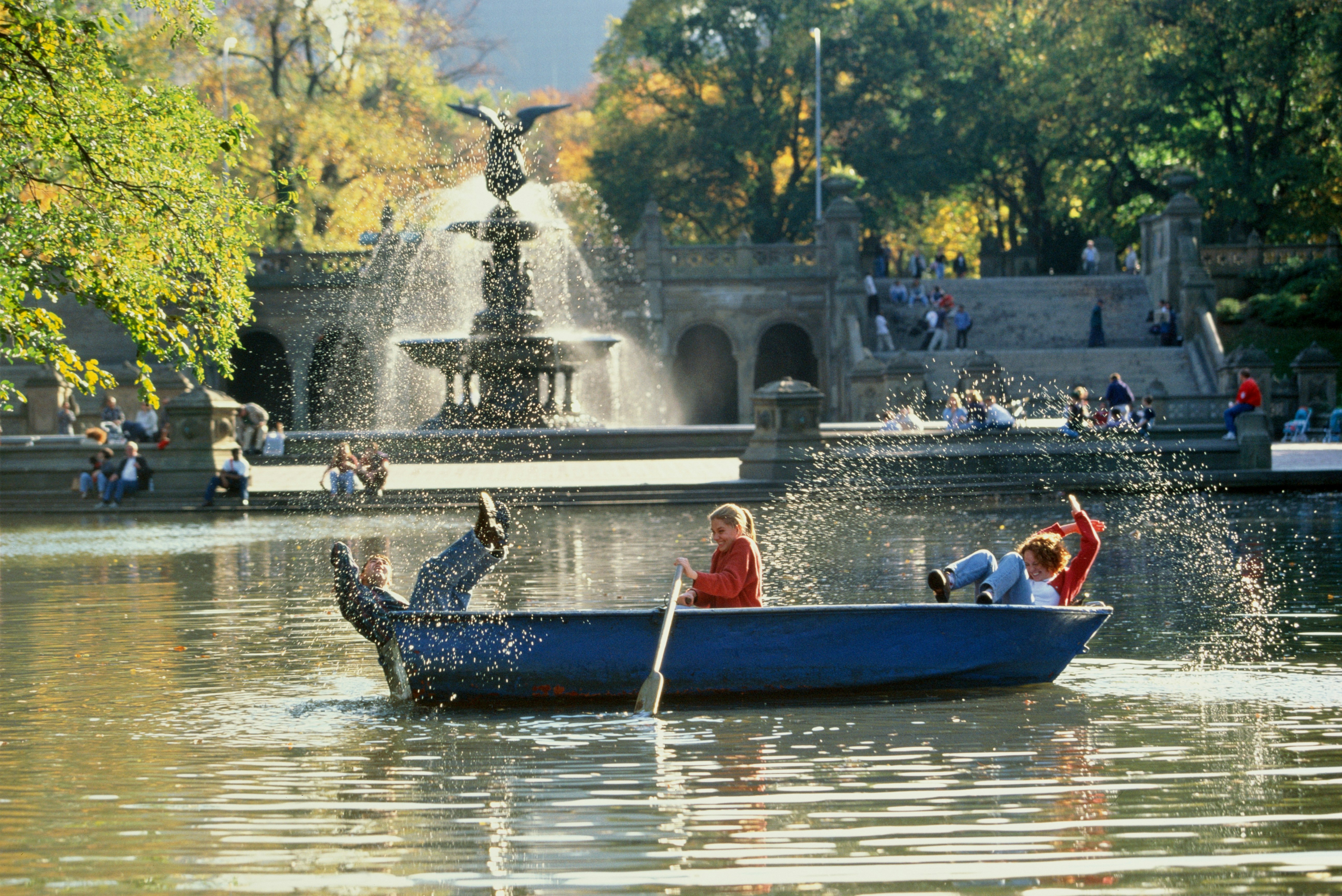 Three young people apparently are about to fall out of a boat in a pond in Central Park, New York City; Where to travel with your tweens and teens