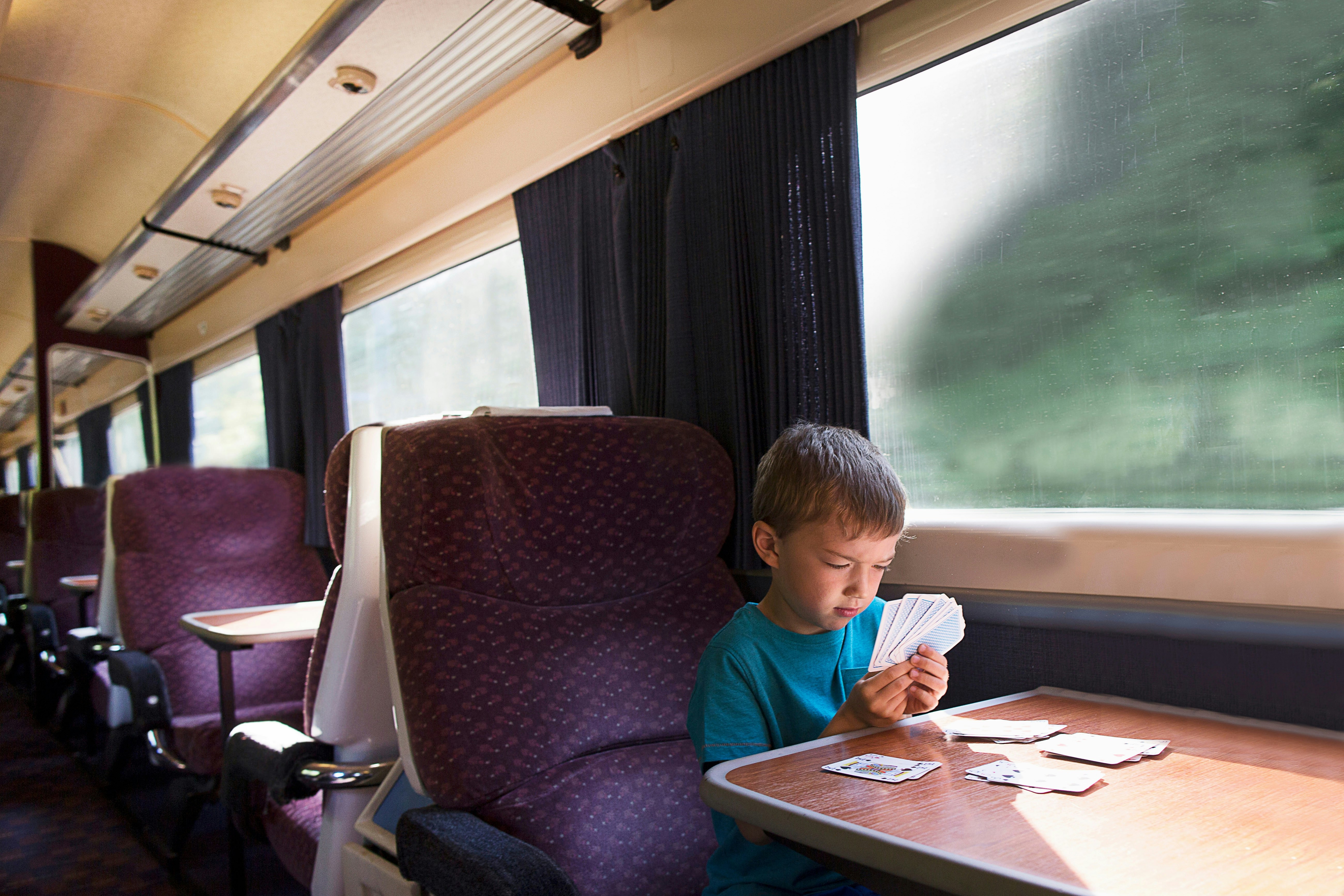 Young boy playing patience on train