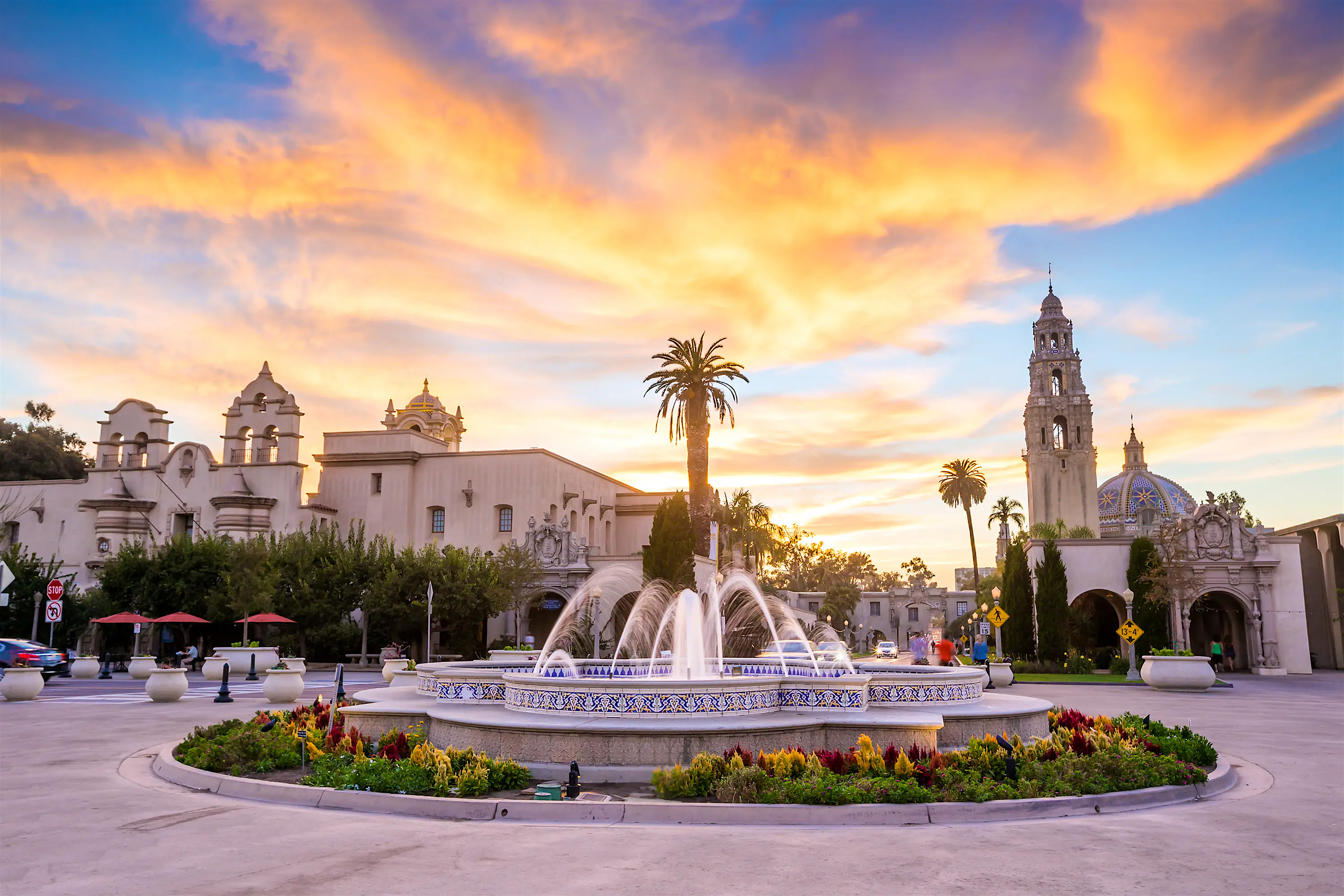 GettyRF_538827265.jpg A neat and tidy square with a fountain and several buildings round the edge seen at twilight