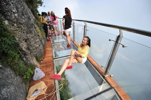People crossing a glass bridge in China