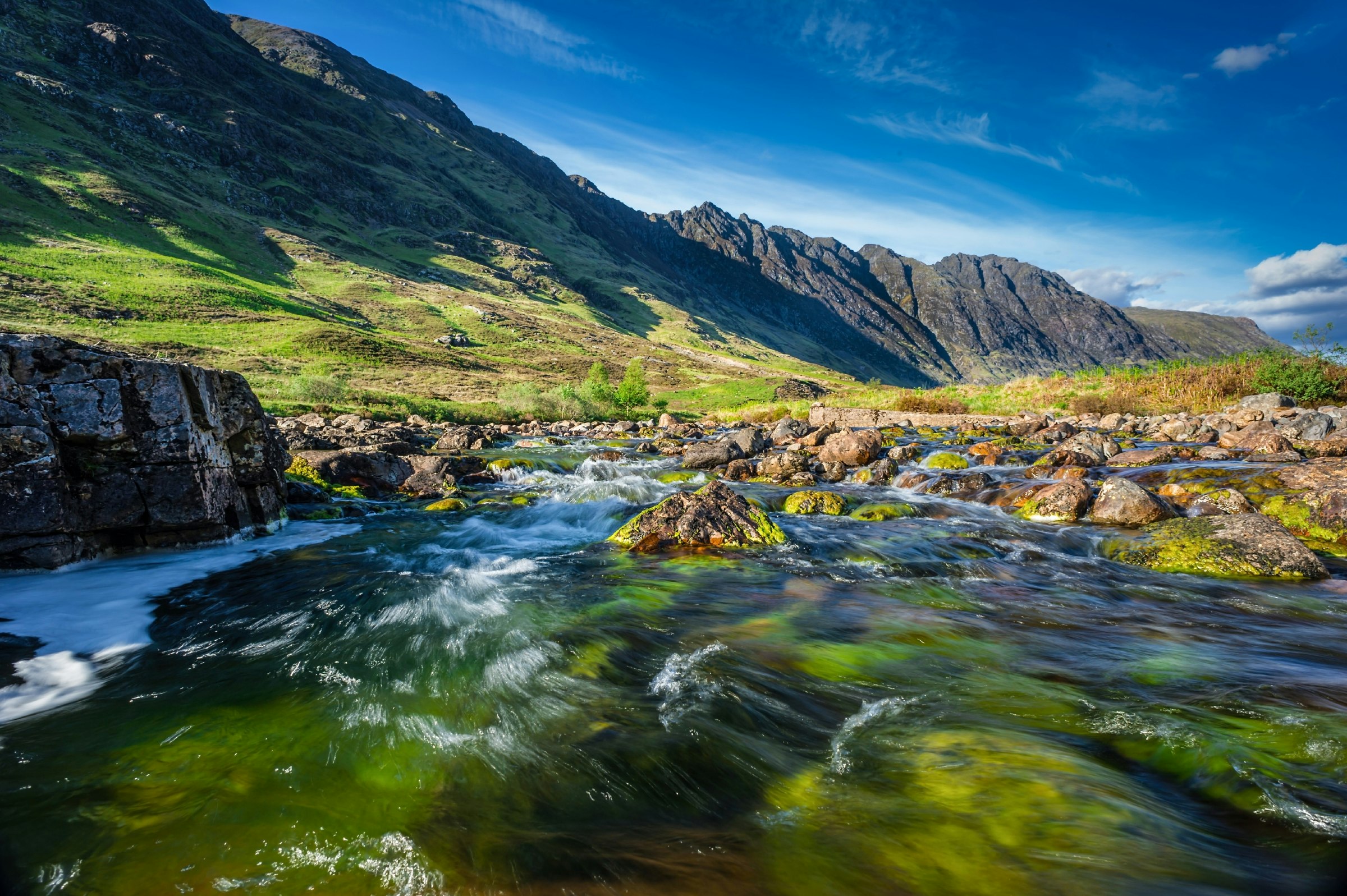 A fresh water stream surrounded by the mountains of Glencoe, in the Scottish Highlands 