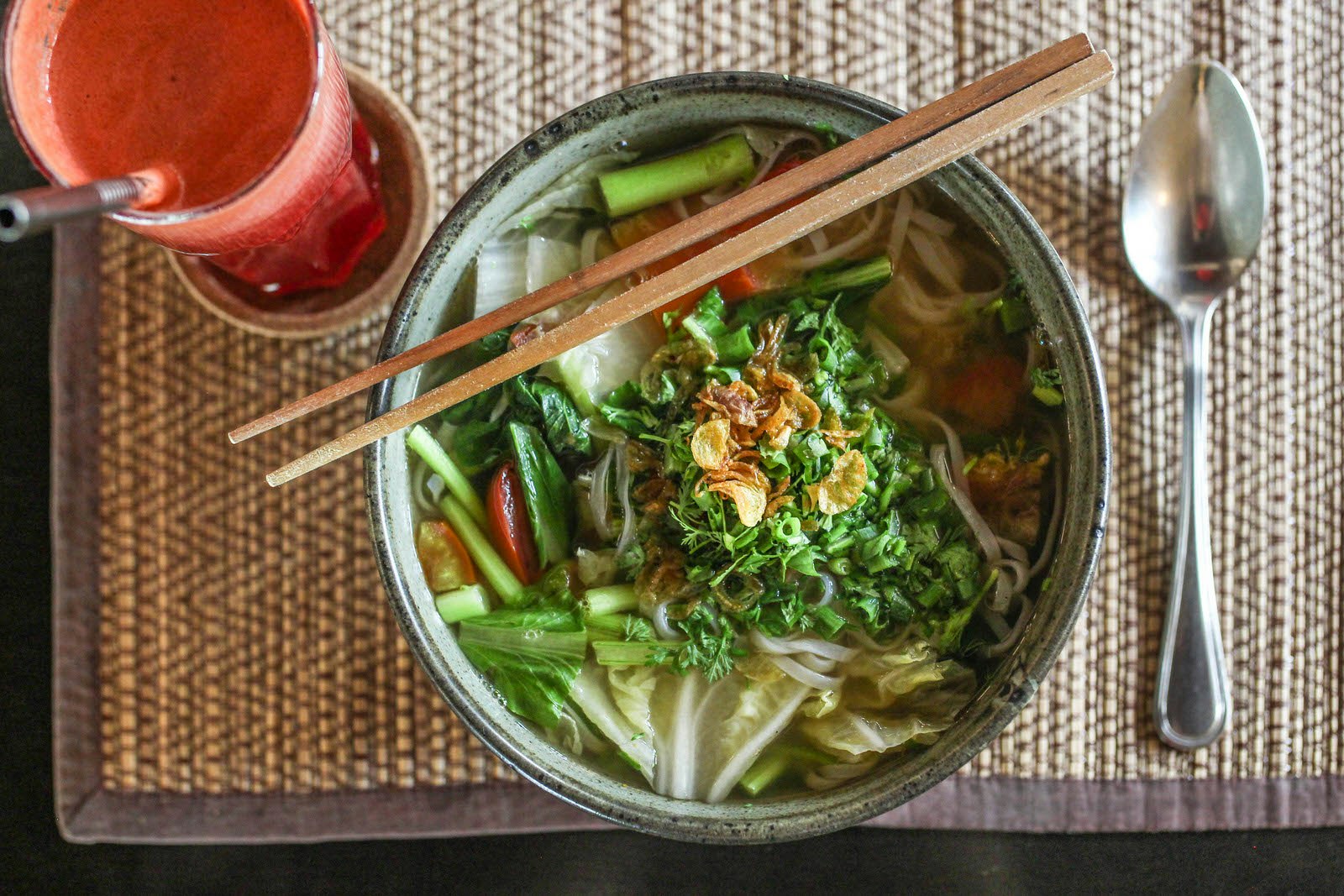 A close up flat lay angle of a vegan ramen and a berry juice served at Goodsouls in Chiang Mai