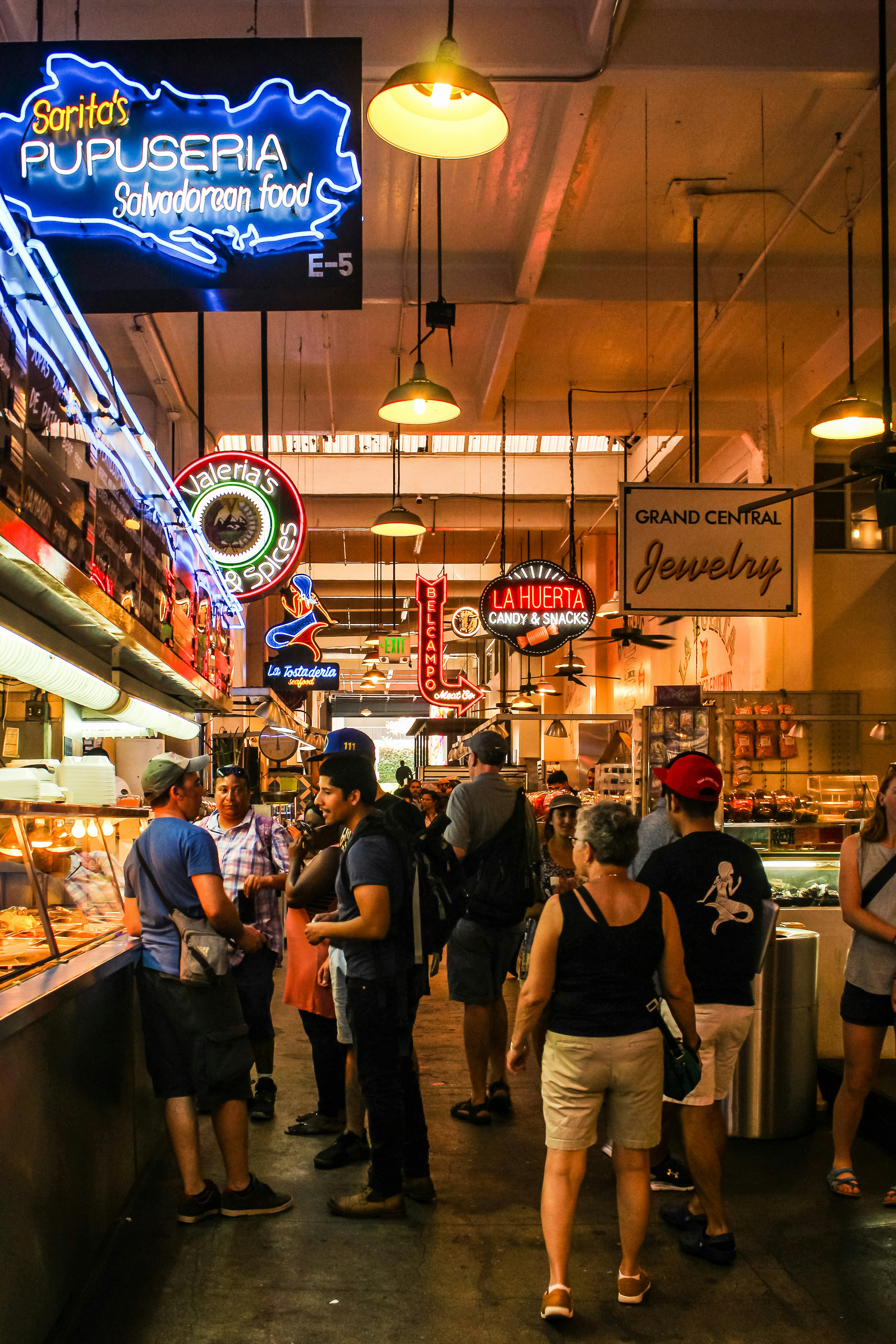 People browse the aisles at an indoor food hall
