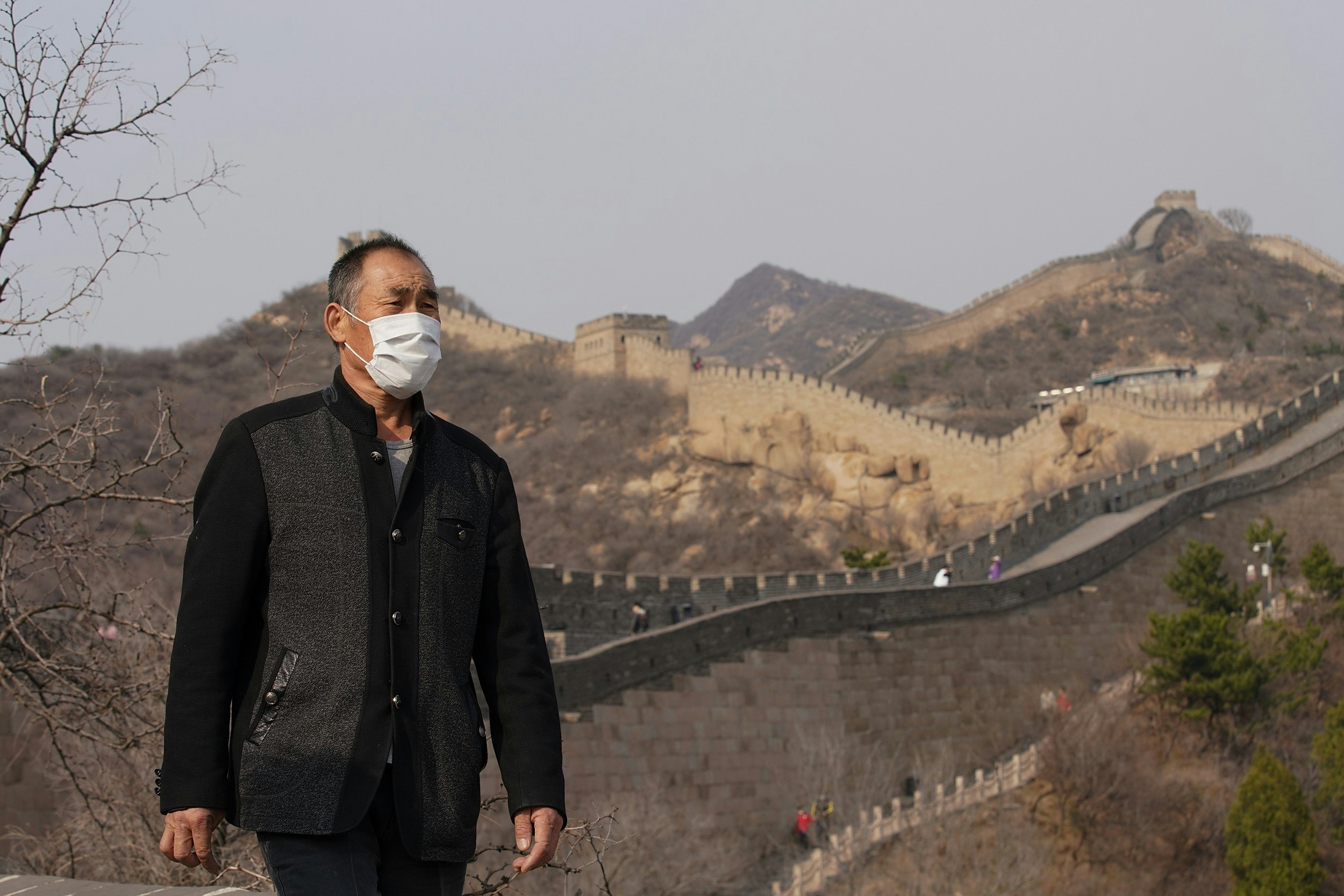 A man wearing a health mask at the Badaling section of the Great Wall of China