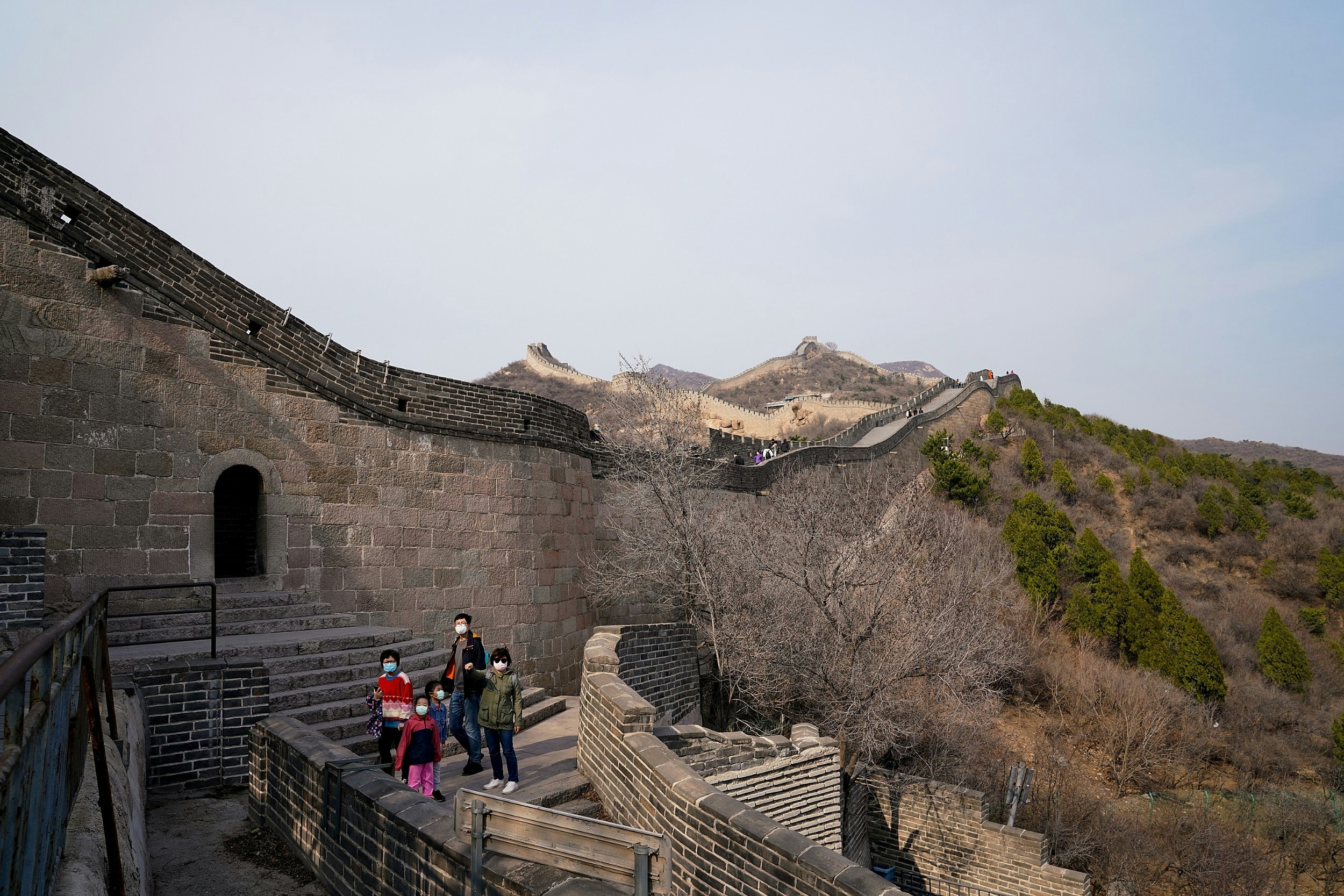 A chinese family wearing a protective masks as they visit the Badaling Great Wall
