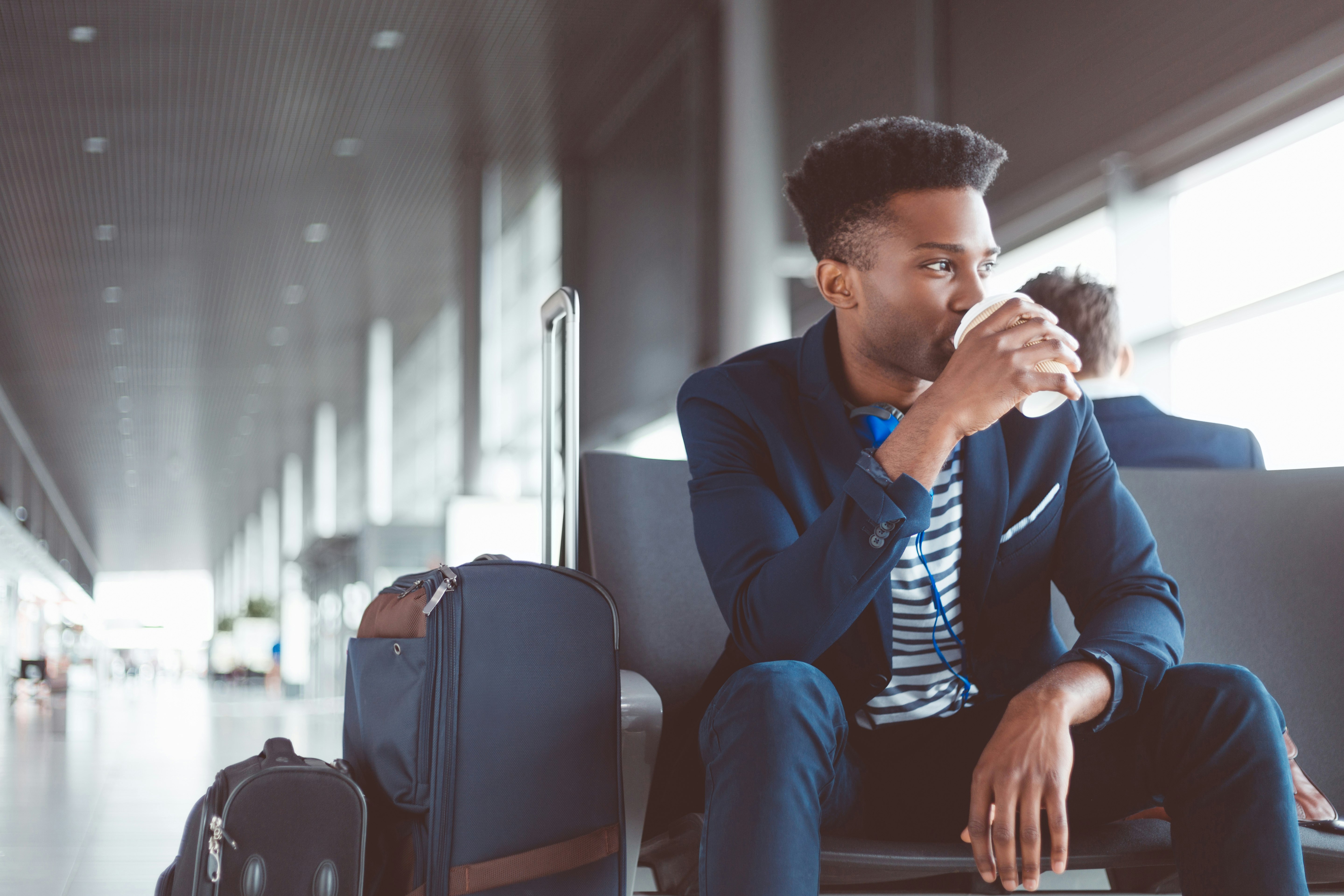 Guy drinking coffee in airport.jpg