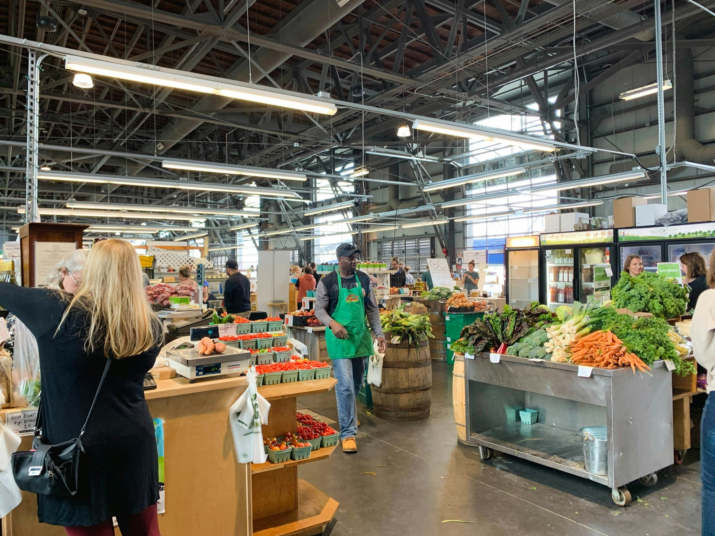 A grocer walks through the checkout section of the oldest farmer's market in North America in Halifax, Nova Scotia, Canada