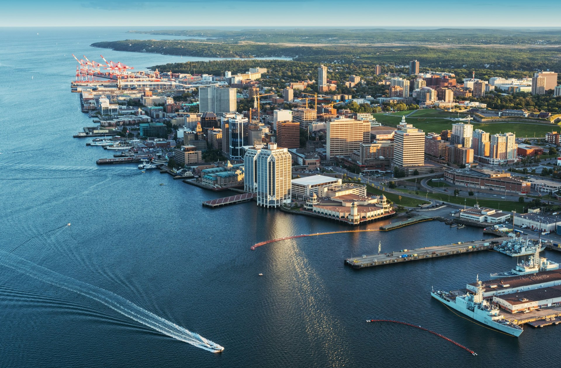A low-altitude aerial look at the Halifax Waterfront in Canada from just offshore with buildings and boats along the coastline