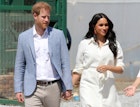 Prince Harry and Meghan Markle olds hands while visiting a Youth Employment Service building in South Africa.