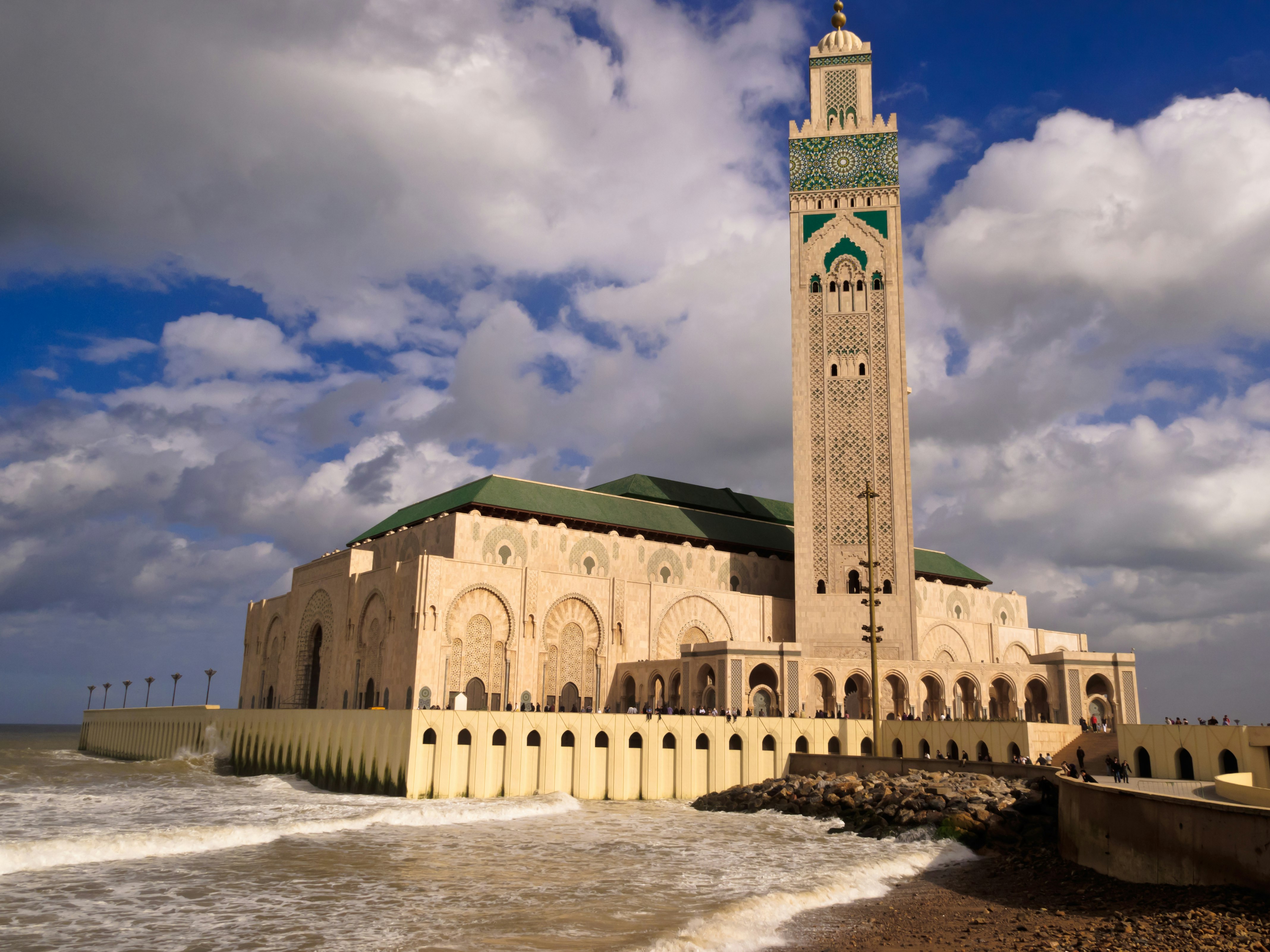 Waves crash against the outer walls of the Hassan II Mosque and Minaret in Casablanca, Morocco