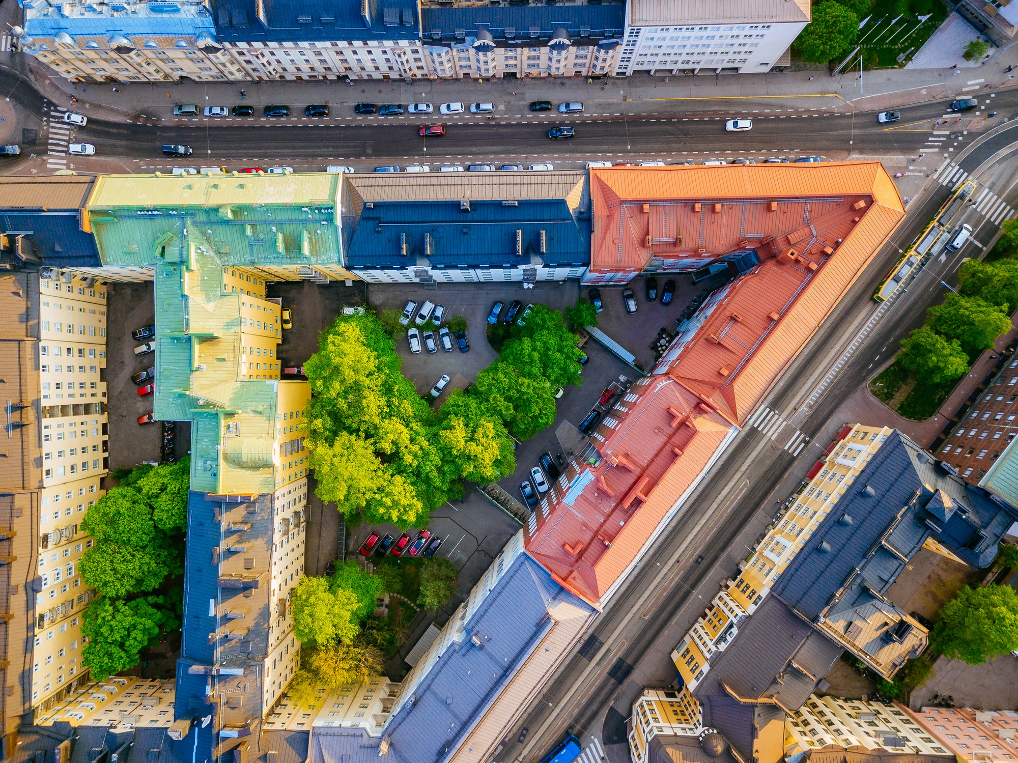 Top-down view of streets, multi-colored rooftops and inner courtyards of old residential buildings in downtown Helsinki