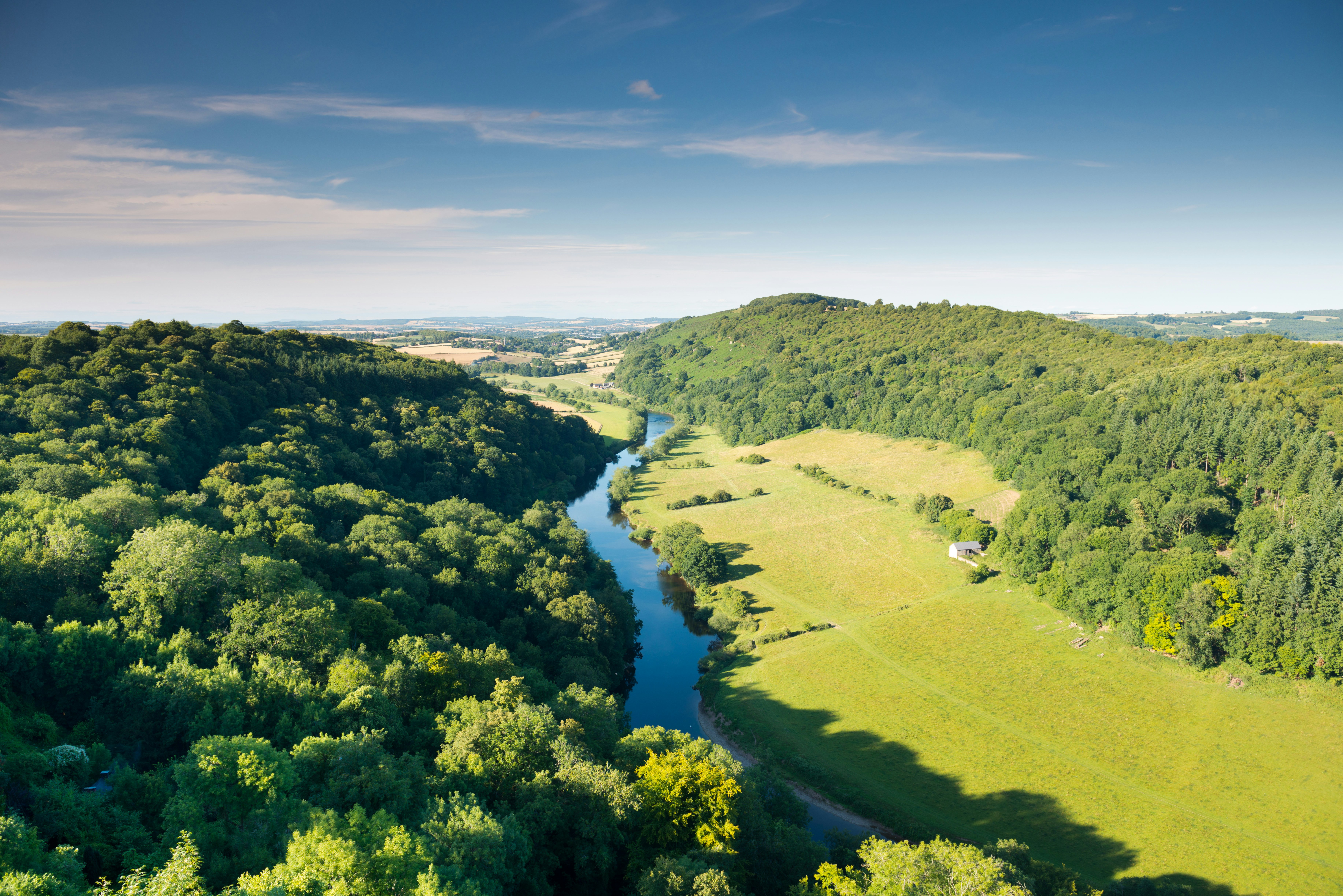 River Wye with rural farmland on one side and forest on the other.
