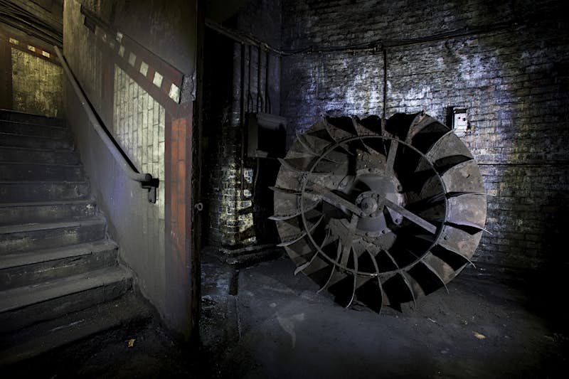 A redundant fan impeller in a dark corner of disused York Road station © Toby Madden and Andy Davis courtesy of The London Transport Museum