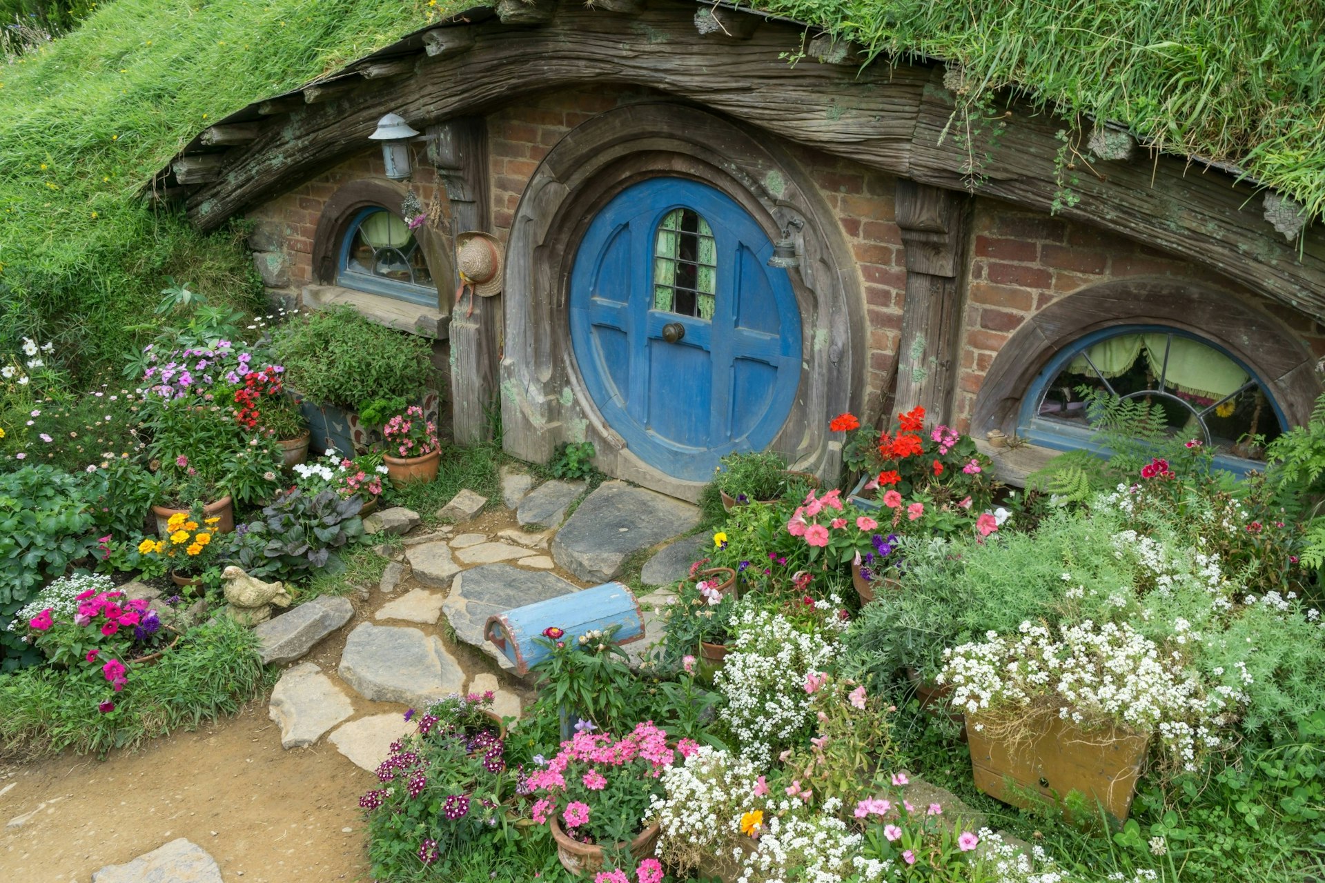Hobbit holes and hobbit gardens in Hobbiton Movie Set, New Zealand.
