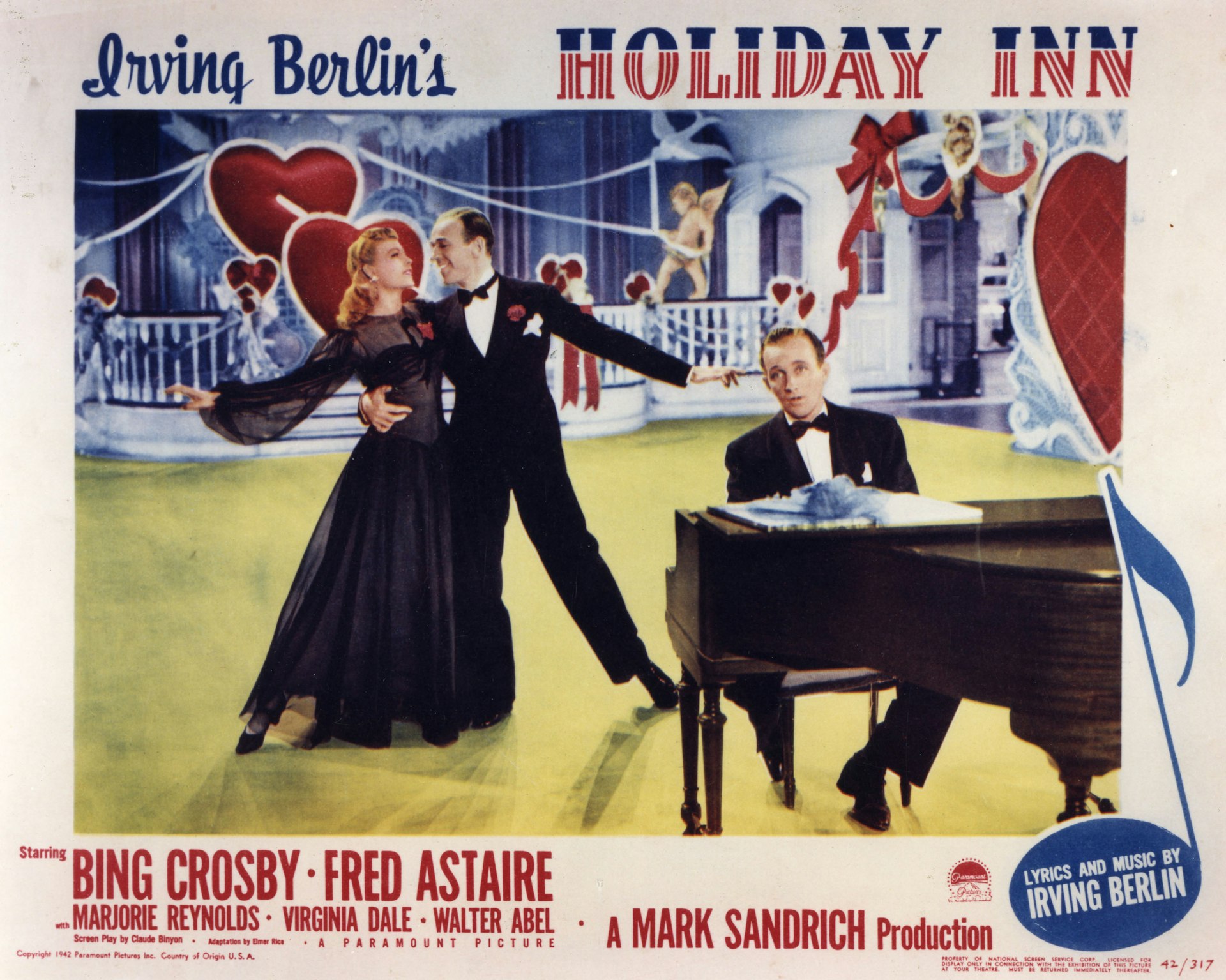 Bing Crosy plays the piano as Fred Astaire dances with Virginia Dale in the poster for Holiday Inn